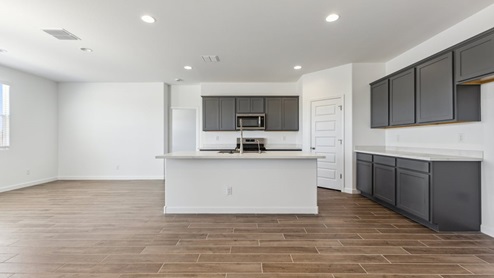 The Garland floor plan is a spacious single-story new home situated in the Agave neighborhood at Saguaro Bloom, offering 2,273 square feet of well-planned living space that perfectly suits a variety of lifestyles. This home features four bedrooms and three full bathrooms making it an ideal choice for families and those needing room to grow. As you step into the front porch and through the front door, you're greeted by the open concept layout with a seamless flow between the living, dining, and kitchen area, ensuring that every part of the home feels connected. The kitchen, equipped with a central island, quartz countertops, and your choice of flat panel Shaker-style cabinet doors with multiple color options available. A walk-in pantry provides additional storage, making it easy to keep everything organized. The Garland's four bedrooms are thoughtfully arranged to provide both privacy and convenience. The primary suite is tucked away at the rear of the home, offering a private retreat with walk-in closets off the en-suite bathroom complete with an optional dual sink vanity. The additional bedrooms are strategically placed near the front and center of the home, each with access to a full bathroom, ensuring comfort for all family members or guests. The large great room serves as the central gathering space, perfect for family activities or entertaining guests. Adjacent to the great room is a covered patio, extending your living space outdoors and offering a perfect spot to enjoy the serene surroundings of Saguaro Bloom. Practical features like a dedicated utility room and a spacious three-car garage enhance the functionality of this home, while large windows ensure that natural light fills the space, creating a bright and inviting atmosphere. Located within the vibrant Saguaro Bloom community, residents of The Garland can take advantage of a wide array of amenities, from resort-style pools to extensive walking trails. This home offers a unique opportunity to enjoy both comfort and community in one of Marana’s most sought-after neighborhoods.