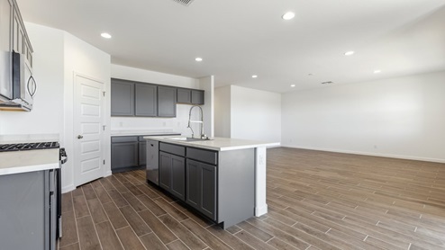 The Garland floor plan is a spacious single-story new home situated in the Agave neighborhood at Saguaro Bloom, offering 2,273 square feet of well-planned living space that perfectly suits a variety of lifestyles. This home features four bedrooms and three full bathrooms making it an ideal choice for families and those needing room to grow. As you step into the front porch and through the front door, you're greeted by the open concept layout with a seamless flow between the living, dining, and kitchen area, ensuring that every part of the home feels connected. The kitchen, equipped with a central island, quartz countertops, and your choice of flat panel Shaker-style cabinet doors with multiple color options available. A walk-in pantry provides additional storage, making it easy to keep everything organized. The Garland's four bedrooms are thoughtfully arranged to provide both privacy and convenience. The primary suite is tucked away at the rear of the home, offering a private retreat with walk-in closets off the en-suite bathroom complete with an optional dual sink vanity. The additional bedrooms are strategically placed near the front and center of the home, each with access to a full bathroom, ensuring comfort for all family members or guests. The large great room serves as the central gathering space, perfect for family activities or entertaining guests. Adjacent to the great room is a covered patio, extending your living space outdoors and offering a perfect spot to enjoy the serene surroundings of Saguaro Bloom. Practical features like a dedicated utility room and a spacious three-car garage enhance the functionality of this home, while large windows ensure that natural light fills the space, creating a bright and inviting atmosphere. Located within the vibrant Saguaro Bloom community, residents of The Garland can take advantage of a wide array of amenities, from resort-style pools to extensive walking trails. This home offers a unique opportunity to enjoy both comfort and community in one of Marana’s most sought-after neighborhoods.