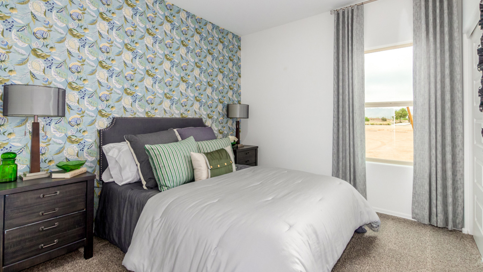 Welcome to The Amber, a thoughtfully designed single-story new home nestled in the Mesquite neighborhood at Saguaro Bloom, a master-planned community in Marana, Arizona. With 1,331 square feet of efficient living space, The Amber is perfect for those seeking a cozy yet functional home.  Step into a welcoming entryway that immediately introduces you to the home’s smart layout. The open design maximizes every square foot, with the heart of the home being the expansive great room, which flows seamlessly into the dining area and kitchen. The kitchen is well-equipped with a central island, granite countertops, and Shaker-style cabinets in either white or gray, offering a clean and modern aesthetic. A dedicated walk-in pantry adds extra storage, ensuring that all your culinary essentials are within reach.  The Amber offers three comfortable bedrooms, providing ample space for rest and relaxation. The primary suite is situated at the rear of the home, providing a sense of privacy. It includes a walk-in closet and an en-suite bathroom that features all the essentials for convenience. The two additional bedrooms are thoughtfully placed near the front of the home, sharing access to a full bathroom, making this layout perfect for families, guests, or a home office.  Practicality meets comfort in this home, with a utility room conveniently located near the kitchen and garage, providing easy access to the laundry area and additional storage. The Amber also includes a covered patio that extends the living space outdoors, ideal for enjoying Arizona’s beautiful weather.  The Amber is located in the vibrant Saguaro Bloom community, residents enjoy access to a wide range of amenities, from swimming pools and parks to miles of scenic walking trails. Whether you’re a first-time homebuyer or looking to downsize, The Amber offers a perfect blend of comfort, style, and convenience in one of Marana’s most desirable neighborhoods.