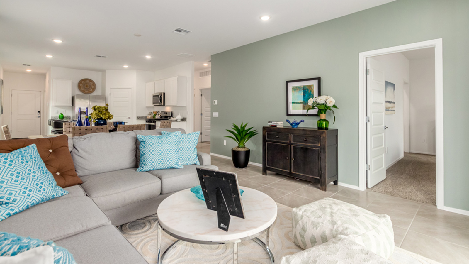 Welcome to The Amber, a thoughtfully designed single-story new home nestled in the Mesquite neighborhood at Saguaro Bloom, a master-planned community in Marana, Arizona. With 1,331 square feet of efficient living space, The Amber is perfect for those seeking a cozy yet functional home.  *Images shown are for reference only. They depict the Amber model home and may not represent the actual home. Step into a welcoming entryway that immediately introduces you to the home’s smart layout. The open design maximizes every square foot, with the heart of the home being the expansive great room, which flows seamlessly into the dining area and kitchen. The kitchen is well-equipped with a central island, granite countertops, and Shaker-style cabinets in either white or gray, offering a clean and modern aesthetic. A dedicated walk-in pantry adds extra storage, ensuring that all your culinary essentials are within reach.  The Amber offers three comfortable bedrooms, providing ample space for rest and relaxation. The primary suite is situated at the rear of the home, providing a sense of privacy. It includes a walk-in closet and an en-suite bathroom that features all the essentials for convenience. The two additional bedrooms are thoughtfully placed near the front of the home, sharing access to a full bathroom, making this layout perfect for families, guests, or a home office.  Practicality meets comfort in this home, with a utility room conveniently located near the kitchen and garage, providing easy access to the laundry area and additional storage. The Amber also includes a covered patio that extends the living space outdoors, ideal for enjoying Arizona’s beautiful weather.  The Amber is located in the vibrant Saguaro Bloom community, residents enjoy access to a wide range of amenities, from swimming pools and parks to miles of scenic walking trails. Whether you’re a first-time homebuyer or looking to downsize, The Amber offers a perfect blend of comfort, style, and convenience in one of Marana’s most desirable neighborhoods.