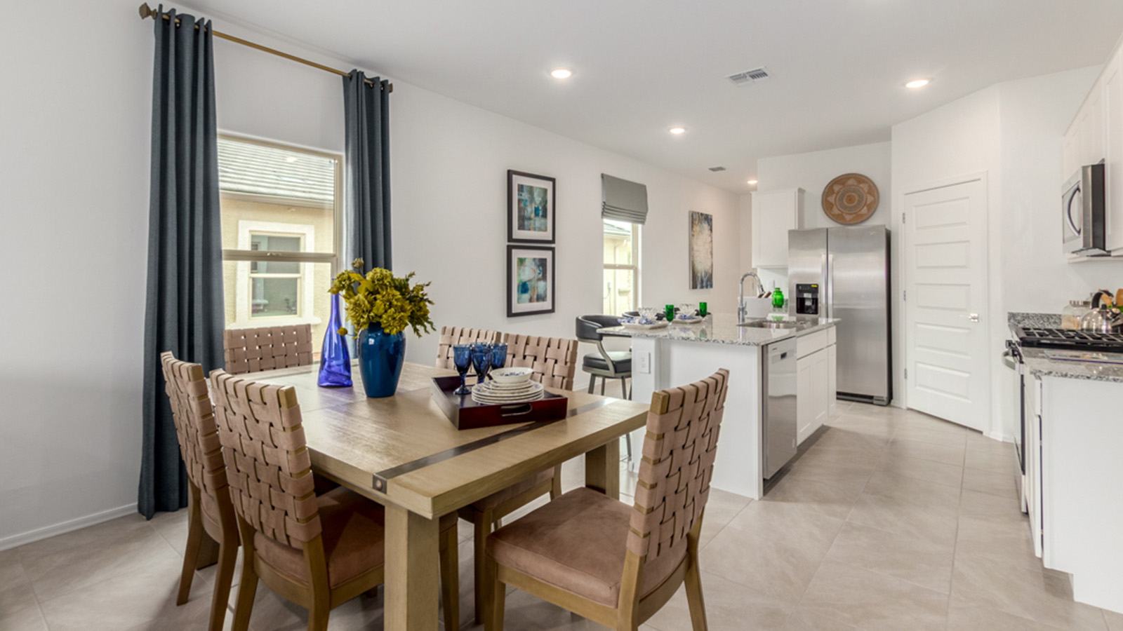 Welcome to The Amber, a thoughtfully designed single-story new home nestled in the Mesquite neighborhood at Saguaro Bloom, a master-planned community in Marana, Arizona. With 1,331 square feet of efficient living space, The Amber is perfect for those seeking a cozy yet functional home.  *Images shown are for reference only. They depict the Amber model home and may not represent the actual home. Step into a welcoming entryway that immediately introduces you to the home’s smart layout. The open design maximizes every square foot, with the heart of the home being the expansive great room, which flows seamlessly into the dining area and kitchen. The kitchen is well-equipped with a central island, granite countertops, and Shaker-style cabinets in either white or gray, offering a clean and modern aesthetic. A dedicated walk-in pantry adds extra storage, ensuring that all your culinary essentials are within reach.  The Amber offers three comfortable bedrooms, providing ample space for rest and relaxation. The primary suite is situated at the rear of the home, providing a sense of privacy. It includes a walk-in closet and an en-suite bathroom that features all the essentials for convenience. The two additional bedrooms are thoughtfully placed near the front of the home, sharing access to a full bathroom, making this layout perfect for families, guests, or a home office.  Practicality meets comfort in this home, with a utility room conveniently located near the kitchen and garage, providing easy access to the laundry area and additional storage. The Amber also includes a covered patio that extends the living space outdoors, ideal for enjoying Arizona’s beautiful weather.  The Amber is located in the vibrant Saguaro Bloom community, residents enjoy access to a wide range of amenities, from swimming pools and parks to miles of scenic walking trails. Whether you’re a first-time homebuyer or looking to downsize, The Amber offers a perfect blend of comfort, style, and convenience in one of Marana’s most desirable neighborhoods.