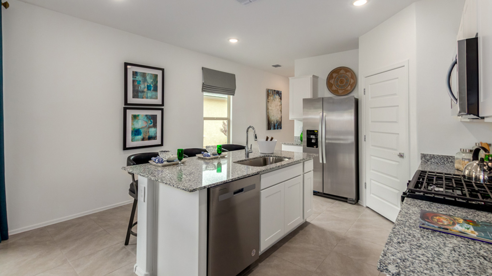 Welcome to The Amber, a thoughtfully designed single-story new home nestled in the Mesquite neighborhood at Saguaro Bloom, a master-planned community in Marana, Arizona. With 1,331 square feet of efficient living space, The Amber is perfect for those seeking a cozy yet functional home.  Step into a welcoming entryway that immediately introduces you to the home’s smart layout. The open design maximizes every square foot, with the heart of the home being the expansive great room, which flows seamlessly into the dining area and kitchen. The kitchen is well-equipped with a central island, granite countertops, and Shaker-style cabinets in either white or gray, offering a clean and modern aesthetic. A dedicated walk-in pantry adds extra storage, ensuring that all your culinary essentials are within reach.  The Amber offers three comfortable bedrooms, providing ample space for rest and relaxation. The primary suite is situated at the rear of the home, providing a sense of privacy. It includes a walk-in closet and an en-suite bathroom that features all the essentials for convenience. The two additional bedrooms are thoughtfully placed near the front of the home, sharing access to a full bathroom, making this layout perfect for families, guests, or a home office.  Practicality meets comfort in this home, with a utility room conveniently located near the kitchen and garage, providing easy access to the laundry area and additional storage. The Amber also includes a covered patio that extends the living space outdoors, ideal for enjoying Arizona’s beautiful weather.  The Amber is located in the vibrant Saguaro Bloom community, residents enjoy access to a wide range of amenities, from swimming pools and parks to miles of scenic walking trails. Whether you’re a first-time homebuyer or looking to downsize, The Amber offers a perfect blend of comfort, style, and convenience in one of Marana’s most desirable neighborhoods.  *Images shown are for reference only. They depict the Amber Model home and may not represent the actual home.