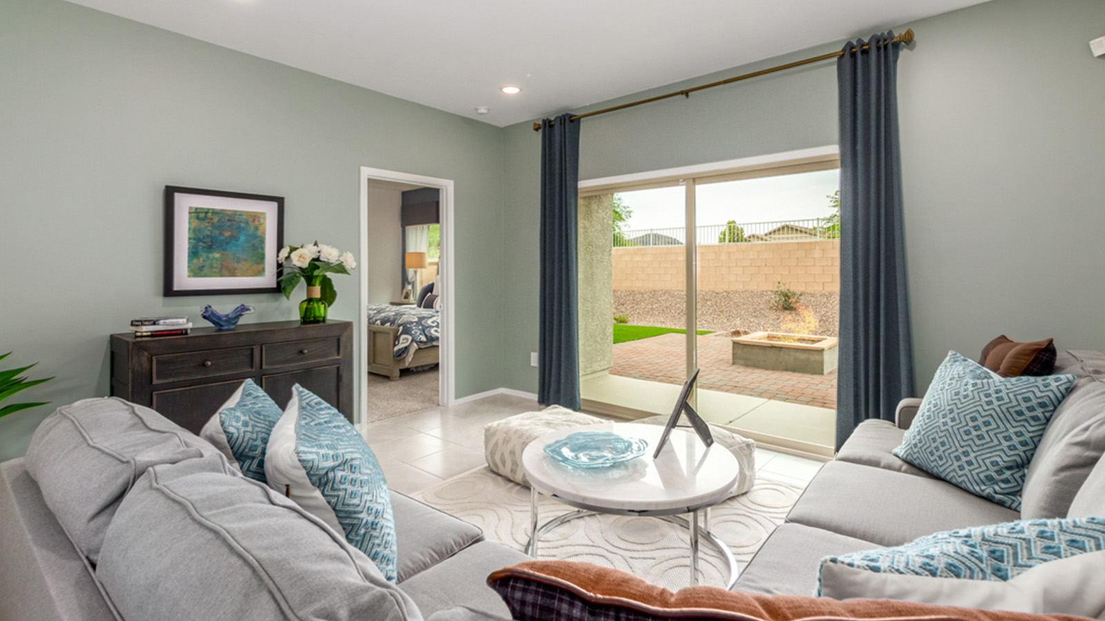 Welcome to The Amber, a thoughtfully designed single-story new home nestled in the Mesquite neighborhood at Saguaro Bloom, a master-planned community in Marana, Arizona. With 1,331 square feet of efficient living space, The Amber is perfect for those seeking a cozy yet functional home.  Step into a welcoming entryway that immediately introduces you to the home’s smart layout. The open design maximizes every square foot, with the heart of the home being the expansive great room, which flows seamlessly into the dining area and kitchen. The kitchen is well-equipped with a central island, granite countertops, and Shaker-style cabinets in either white or gray, offering a clean and modern aesthetic. A dedicated walk-in pantry adds extra storage, ensuring that all your culinary essentials are within reach.  The Amber offers three comfortable bedrooms, providing ample space for rest and relaxation. The primary suite is situated at the rear of the home, providing a sense of privacy. It includes a walk-in closet and an en-suite bathroom that features all the essentials for convenience. The two additional bedrooms are thoughtfully placed near the front of the home, sharing access to a full bathroom, making this layout perfect for families, guests, or a home office.  Practicality meets comfort in this home, with a utility room conveniently located near the kitchen and garage, providing easy access to the laundry area and additional storage. The Amber also includes a covered patio that extends the living space outdoors, ideal for enjoying Arizona’s beautiful weather.  The Amber is located in the vibrant Saguaro Bloom community, residents enjoy access to a wide range of amenities, from swimming pools and parks to miles of scenic walking trails. Whether you’re a first-time homebuyer or looking to downsize, The Amber offers a perfect blend of comfort, style, and convenience in one of Marana’s most desirable neighborhoods.  *Images shown are for reference only. They depict the sales model home and may not represent the actual home.