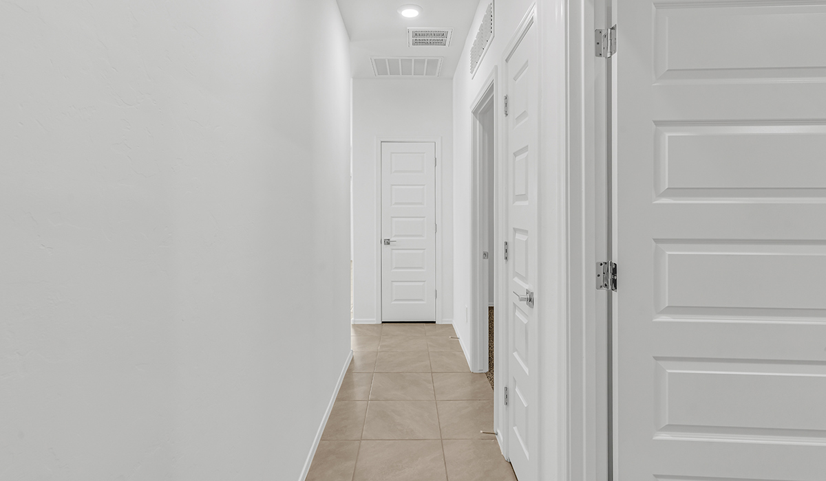 Welcome to The Amber, a thoughtfully designed single-story new home nestled in the Mesquite neighborhood at Saguaro Bloom, a master-planned community in Marana, Arizona. With 1,331 square feet of efficient living space, The Amber is perfect for those seeking a cozy yet functional home.  Step into a welcoming entryway that immediately introduces you to the home’s smart layout. The open design maximizes every square foot, with the heart of the home being the expansive great room, which flows seamlessly into the dining area and kitchen. The kitchen is well-equipped with a central island, granite countertops, and Shaker-style cabinets in either white or gray, offering a clean and modern aesthetic. A dedicated walk-in pantry adds extra storage, ensuring that all your culinary essentials are within reach.  The Amber offers three comfortable bedrooms, providing ample space for rest and relaxation. The primary suite is situated at the rear of the home, providing a sense of privacy. It includes a walk-in closet and an en-suite bathroom that features all the essentials for convenience. The two additional bedrooms are thoughtfully placed near the front of the home, sharing access to a full bathroom, making this layout perfect for families, guests, or a home office.  Practicality meets comfort in this home, with a utility room conveniently located near the kitchen and garage, providing easy access to the laundry area and additional storage. The Amber also includes a covered patio that extends the living space outdoors, ideal for enjoying Arizona’s beautiful weather.  The Amber is located in the vibrant Saguaro Bloom community, residents enjoy access to a wide range of amenities, from swimming pools and parks to miles of scenic walking trails. Whether you’re a first-time homebuyer or looking to downsize, The Amber offers a perfect blend of comfort, style, and convenience in one of Marana’s most desirable neighborhoods.  *Images shown are for reference only. They depict the Amber model home and may not represent the actual home.