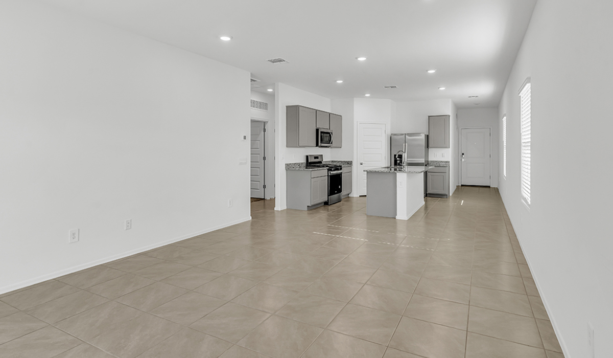 Welcome to The Amber, a thoughtfully designed single-story new home nestled in the Mesquite neighborhood at Saguaro Bloom, a master-planned community in Marana, Arizona. With 1,331 square feet of efficient living space, The Amber is perfect for those seeking a cozy yet functional home.  Step into a welcoming entryway that immediately introduces you to the home’s smart layout. The open design maximizes every square foot, with the heart of the home being the expansive great room, which flows seamlessly into the dining area and kitchen. The kitchen is well-equipped with a central island, granite countertops, and Shaker-style cabinets in either white or gray, offering a clean and modern aesthetic. A dedicated walk-in pantry adds extra storage, ensuring that all your culinary essentials are within reach.  The Amber offers three comfortable bedrooms, providing ample space for rest and relaxation. The primary suite is situated at the rear of the home, providing a sense of privacy. It includes a walk-in closet and an en-suite bathroom that features all the essentials for convenience. The two additional bedrooms are thoughtfully placed near the front of the home, sharing access to a full bathroom, making this layout perfect for families, guests, or a home office.  Practicality meets comfort in this home, with a utility room conveniently located near the kitchen and garage, providing easy access to the laundry area and additional storage. The Amber also includes a covered patio that extends the living space outdoors, ideal for enjoying Arizona’s beautiful weather.  The Amber is located in the vibrant Saguaro Bloom community, residents enjoy access to a wide range of amenities, from swimming pools and parks to miles of scenic walking trails. Whether you’re a first-time homebuyer or looking to downsize, The Amber offers a perfect blend of comfort, style, and convenience in one of Marana’s most desirable neighborhoods.  *Images shown are for reference only. They depict the Amber model home and may not represent the actual home.