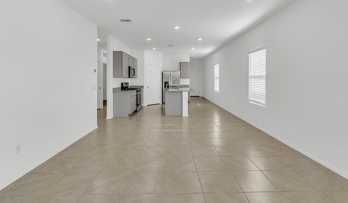 Welcome to The Amber, a thoughtfully designed single-story new home nestled in the Mesquite neighborhood at Saguaro Bloom, a master-planned community in Marana, Arizona. With 1,331 square feet of efficient living space, The Amber is perfect for those seeking a cozy yet functional home.  Step into a welcoming entryway that immediately introduces you to the home’s smart layout. The open design maximizes every square foot, with the heart of the home being the expansive great room, which flows seamlessly into the dining area and kitchen. The kitchen is well-equipped with a central island, granite countertops, and Shaker-style cabinets in either white or gray, offering a clean and modern aesthetic. A dedicated walk-in pantry adds extra storage, ensuring that all your culinary essentials are within reach.  The Amber offers three comfortable bedrooms, providing ample space for rest and relaxation. The primary suite is situated at the rear of the home, providing a sense of privacy. It includes a walk-in closet and an en-suite bathroom that features all the essentials for convenience. The two additional bedrooms are thoughtfully placed near the front of the home, sharing access to a full bathroom, making this layout perfect for families, guests, or a home office.  Practicality meets comfort in this home, with a utility room conveniently located near the kitchen and garage, providing easy access to the laundry area and additional storage. The Amber also includes a covered patio that extends the living space outdoors, ideal for enjoying Arizona’s beautiful weather.  The Amber is located in the vibrant Saguaro Bloom community, residents enjoy access to a wide range of amenities, from swimming pools and parks to miles of scenic walking trails. Whether you’re a first-time homebuyer or looking to downsize, The Amber offers a perfect blend of comfort, style, and convenience in one of Marana’s most desirable neighborhoods.  *Images shown are for reference only. They depict the Amber model home and may not represent the actual home.