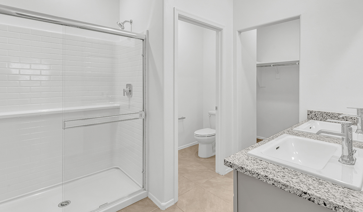 Welcome to The Amber, a thoughtfully designed single-story new home nestled in the Mesquite neighborhood at Saguaro Bloom, a master-planned community in Marana, Arizona. With 1,331 square feet of efficient living space, The Amber is perfect for those seeking a cozy yet functional home.  Step into a welcoming entryway that immediately introduces you to the home’s smart layout. The open design maximizes every square foot, with the heart of the home being the expansive great room, which flows seamlessly into the dining area and kitchen. The kitchen is well-equipped with a central island, granite countertops, and Shaker-style cabinets in either white or gray, offering a clean and modern aesthetic. A dedicated walk-in pantry adds extra storage, ensuring that all your culinary essentials are within reach.  The Amber offers three comfortable bedrooms, providing ample space for rest and relaxation. The primary suite is situated at the rear of the home, providing a sense of privacy. It includes a walk-in closet and an en-suite bathroom that features all the essentials for convenience. The two additional bedrooms are thoughtfully placed near the front of the home, sharing access to a full bathroom, making this layout perfect for families, guests, or a home office.  Practicality meets comfort in this home, with a utility room conveniently located near the kitchen and garage, providing easy access to the laundry area and additional storage. The Amber also includes a covered patio that extends the living space outdoors, ideal for enjoying Arizona’s beautiful weather.  The Amber is located in the vibrant Saguaro Bloom community, residents enjoy access to a wide range of amenities, from swimming pools and parks to miles of scenic walking trails. Whether you’re a first-time homebuyer or looking to downsize, The Amber offers a perfect blend of comfort, style, and convenience in one of Marana’s most desirable neighborhoods.  *Images shown are for reference only. They depict the Amber model home and may not represent the actual home.