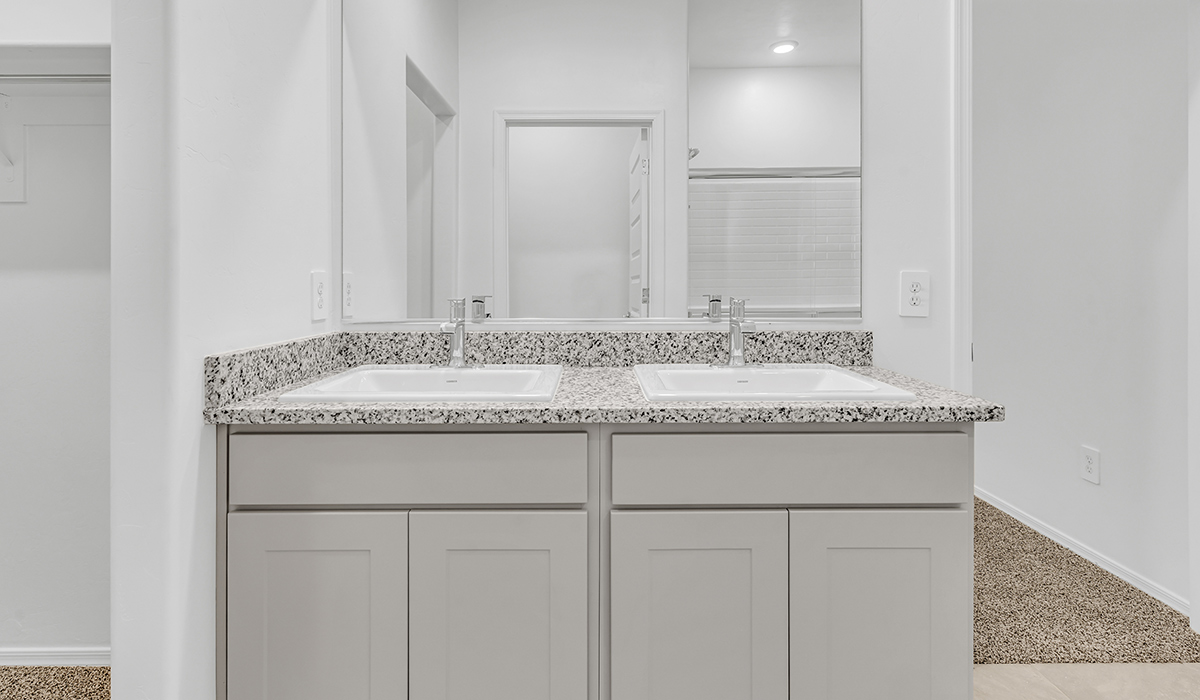 Welcome to The Amber, a thoughtfully designed single-story new home nestled in the Mesquite neighborhood at Saguaro Bloom, a master-planned community in Marana, Arizona. With 1,331 square feet of efficient living space, The Amber is perfect for those seeking a cozy yet functional home.  Step into a welcoming entryway that immediately introduces you to the home’s smart layout. The open design maximizes every square foot, with the heart of the home being the expansive great room, which flows seamlessly into the dining area and kitchen. The kitchen is well-equipped with a central island, granite countertops, and Shaker-style cabinets in either white or gray, offering a clean and modern aesthetic. A dedicated walk-in pantry adds extra storage, ensuring that all your culinary essentials are within reach.  The Amber offers three comfortable bedrooms, providing ample space for rest and relaxation. The primary suite is situated at the rear of the home, providing a sense of privacy. It includes a walk-in closet and an en-suite bathroom that features all the essentials for convenience. The two additional bedrooms are thoughtfully placed near the front of the home, sharing access to a full bathroom, making this layout perfect for families, guests, or a home office.  Practicality meets comfort in this home, with a utility room conveniently located near the kitchen and garage, providing easy access to the laundry area and additional storage. The Amber also includes a covered patio that extends the living space outdoors, ideal for enjoying Arizona’s beautiful weather.  The Amber is located in the vibrant Saguaro Bloom community, residents enjoy access to a wide range of amenities, from swimming pools and parks to miles of scenic walking trails. Whether you’re a first-time homebuyer or looking to downsize, The Amber offers a perfect blend of comfort, style, and convenience in one of Marana’s most desirable neighborhoods.  *Images shown are for reference only. They depict the Amber model home and may not represent the actual home.