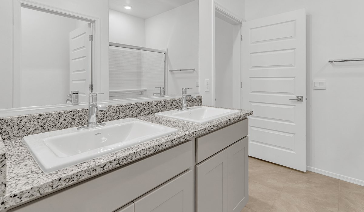 Welcome to The Amber, a thoughtfully designed single-story new home nestled in the Mesquite neighborhood at Saguaro Bloom, a master-planned community in Marana, Arizona. With 1,331 square feet of efficient living space, The Amber is perfect for those seeking a cozy yet functional home.  Step into a welcoming entryway that immediately introduces you to the home’s smart layout. The open design maximizes every square foot, with the heart of the home being the expansive great room, which flows seamlessly into the dining area and kitchen. The kitchen is well-equipped with a central island, granite countertops, and Shaker-style cabinets in either white or gray, offering a clean and modern aesthetic. A dedicated walk-in pantry adds extra storage, ensuring that all your culinary essentials are within reach.  The Amber offers three comfortable bedrooms, providing ample space for rest and relaxation. The primary suite is situated at the rear of the home, providing a sense of privacy. It includes a walk-in closet and an en-suite bathroom that features all the essentials for convenience. The two additional bedrooms are thoughtfully placed near the front of the home, sharing access to a full bathroom, making this layout perfect for families, guests, or a home office.  Practicality meets comfort in this home, with a utility room conveniently located near the kitchen and garage, providing easy access to the laundry area and additional storage. The Amber also includes a covered patio that extends the living space outdoors, ideal for enjoying Arizona’s beautiful weather.  The Amber is located in the vibrant Saguaro Bloom community, residents enjoy access to a wide range of amenities, from swimming pools and parks to miles of scenic walking trails. Whether you’re a first-time homebuyer or looking to downsize, The Amber offers a perfect blend of comfort, style, and convenience in one of Marana’s most desirable neighborhoods.  *Images shown are for reference only. They depict the Amber model home and may not represent the actual home.