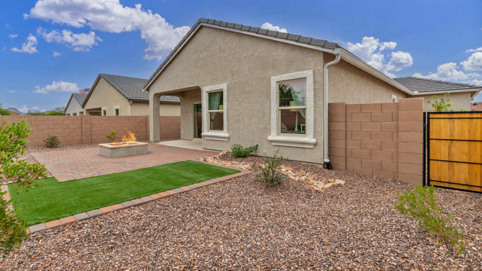 Welcome to The Amber, a thoughtfully designed single-story new home nestled in the Mesquite neighborhood at Saguaro Bloom, a master-planned community in Marana, Arizona. With 1,331 square feet of efficient living space, The Amber is perfect for those seeking a cozy yet functional home.  Step into a welcoming entryway that immediately introduces you to the home’s smart layout. The open design maximizes every square foot, with the heart of the home being the expansive great room, which flows seamlessly into the dining area and kitchen. The kitchen is well-equipped with a central island, granite countertops, and Shaker-style cabinets in either white or gray, offering a clean and modern aesthetic. A dedicated walk-in pantry adds extra storage, ensuring that all your culinary essentials are within reach.  The Amber offers three comfortable bedrooms, providing ample space for rest and relaxation. The primary suite is situated at the rear of the home, providing a sense of privacy. It includes a walk-in closet and an en-suite bathroom that features all the essentials for convenience. The two additional bedrooms are thoughtfully placed near the front of the home, sharing access to a full bathroom, making this layout perfect for families, guests, or a home office.  Practicality meets comfort in this home, with a utility room conveniently located near the kitchen and garage, providing easy access to the laundry area and additional storage. The Amber also includes a covered patio that extends the living space outdoors, ideal for enjoying Arizona’s beautiful weather.  The Amber is located in the vibrant Saguaro Bloom community, residents enjoy access to a wide range of amenities, from swimming pools and parks to miles of scenic walking trails. Whether you’re a first-time homebuyer or looking to downsize, The Amber offers a perfect blend of comfort, style, and convenience in one of Marana’s most desirable neighborhoods.  *Images shown are for reference only. They depict The Amber sales model home and may not represent the actual home.
