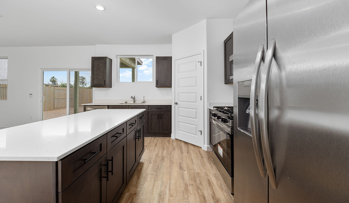 Introducing the Elm floor plan, a thoughtfully designed two-story home now available in the master planned community of Saguaro Bloom by D.R. Horton in Marana, Arizona. With 1,775 square feet of modern living space, the Elm is perfect for those seeking a cozy yet highly functional home that offers a smart separation between the private second-floor retreat and the main living areas below.  Step through the inviting front porch into a welcoming entryway that opens into the main first floor, designed to maximize every inch of space. The expansive great room flows into the dining area and kitchen, creating an ideal layout for entertaining and everyday living. The kitchen features stainless steel gas range, microwave, and dishwasher, and ample countertop and cabinetry storage. A conveniently located powder room completes the first floor. This home features a finished two-car garage accessible from the main floor.  Upstairs, the Elm offers four spacious bedrooms each with a generous closet. The primary suite provides a peaceful retreat with a walk-in closet and en-suite bathroom. The three additional bedrooms are situated just off the versatile loft area, ideal for an extra living space, game room, or home office. Everyday convenience is built in, with the laundry room and a full secondary bathroom also located on the second floor.  Step outside to a spacious backyard, where you can unwind and enjoy Marana’s beautiful weather year-round. Whether you’re sipping your morning coffee or hosting a weekend barbecue, this outdoor space serene surroundings of Saguaro Bloom.  Additionally, The Elm is equipped with D.R. Horton’s Home is Connected Smart Home package, which includes a smart thermostat, video doorbell, keyless entry, and Wi-Fi® enabled garage door opener.  Residents of Saguaro Bloom enjoy an array of community amenities, including a clubhouse, two pools with lap lanes and lagoon entry, a fitness center, a splash pad, and over 30 miles of walking trails. The community also features more than 20 pocket parks, playgrounds, and coming soon, a large community park with tennis, pickleball, soccer, baseball, and a dog park.  Located in the highly-rated Marana Unified School District, Saguaro Bloom is close to excellent schools, including Rattlesnake Ridge Elementary, Marana Middle School, and Marana High School.