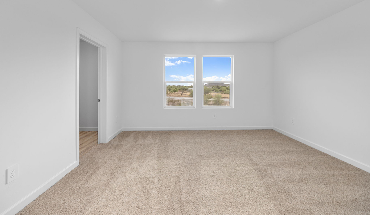 Introducing the Elm floor plan, a thoughtfully designed two-story home now available in the master planned community of Saguaro Bloom by D.R. Horton in Marana, Arizona. With 1,775 square feet of modern living space, the Elm is perfect for those seeking a cozy yet highly functional home that offers a smart separation between the private second-floor retreat and the main living areas below.  Step through the inviting front porch into a welcoming entryway that opens into the main first floor, designed to maximize every inch of space. The expansive great room flows into the dining area and kitchen, creating an ideal layout for entertaining and everyday living. The kitchen features stainless steel gas range, microwave, and dishwasher, and ample countertop and cabinetry storage. A conveniently located powder room completes the first floor. This home features a finished two-car garage accessible from the main floor.  Upstairs, the Elm offers four spacious bedrooms each with a generous closet. The primary suite provides a peaceful retreat with a walk-in closet and en-suite bathroom. The three additional bedrooms are situated just off the versatile loft area, ideal for an extra living space, game room, or home office. Everyday convenience is built in, with the laundry room and a full secondary bathroom also located on the second floor.  Step outside to a spacious backyard, where you can unwind and enjoy Marana’s beautiful weather year-round. Whether you’re sipping your morning coffee or hosting a weekend barbecue, this outdoor space serene surroundings of Saguaro Bloom.  Additionally, The Elm is equipped with D.R. Horton’s Home is Connected Smart Home package, which includes a smart thermostat, video doorbell, keyless entry, and Wi-Fi® enabled garage door opener.  Residents of Saguaro Bloom enjoy an array of community amenities, including a clubhouse, two pools with lap lanes and lagoon entry, a fitness center, a splash pad, and over 30 miles of walking trails. The community also features more than 20 pocket parks, playgrounds, and coming soon, a large community park with tennis, pickleball, soccer, baseball, and a dog park.  Located in the highly-rated Marana Unified School District, Saguaro Bloom is close to excellent schools, including Rattlesnake Ridge Elementary, Marana Middle School, and Marana High School.