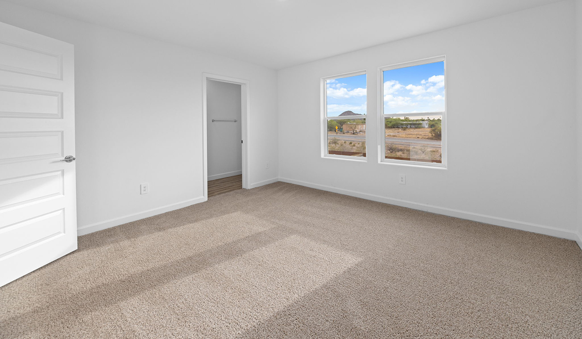 Introducing the Elm floor plan, a thoughtfully designed two-story home now available in the master planned community of Saguaro Bloom by D.R. Horton in Marana, Arizona. With 1,775 square feet of modern living space, the Elm is perfect for those seeking a cozy yet highly functional home that offers a smart separation between the private second-floor retreat and the main living areas below.  Step through the inviting front porch into a welcoming entryway that opens into the main first floor, designed to maximize every inch of space. The expansive great room flows into the dining area and kitchen, creating an ideal layout for entertaining and everyday living. The kitchen features stainless steel gas range, microwave, and dishwasher, and ample countertop and cabinetry storage. A conveniently located powder room completes the first floor. This home features a finished two-car garage accessible from the main floor.  Upstairs, the Elm offers four spacious bedrooms each with a generous closet. The primary suite provides a peaceful retreat with a walk-in closet and en-suite bathroom. The three additional bedrooms are situated just off the versatile loft area, ideal for an extra living space, game room, or home office. Everyday convenience is built in, with the laundry room and a full secondary bathroom also located on the second floor.  Step outside to a spacious backyard, where you can unwind and enjoy Marana’s beautiful weather year-round. Whether you’re sipping your morning coffee or hosting a weekend barbecue, this outdoor space serene surroundings of Saguaro Bloom.  Additionally, The Elm is equipped with D.R. Horton’s Home is Connected Smart Home package, which includes a smart thermostat, video doorbell, keyless entry, and Wi-Fi® enabled garage door opener.  Residents of Saguaro Bloom enjoy an array of community amenities, including a clubhouse, two pools with lap lanes and lagoon entry, a fitness center, a splash pad, and over 30 miles of walking trails. The community also features more than 20 pocket parks, playgrounds, and coming soon, a large community park with tennis, pickleball, soccer, baseball, and a dog park.  Located in the highly-rated Marana Unified School District, Saguaro Bloom is close to excellent schools, including Rattlesnake Ridge Elementary, Marana Middle School, and Marana High School.