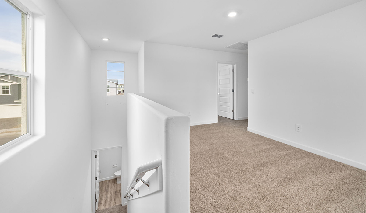 Introducing the Elm floor plan, a thoughtfully designed two-story home now available in the master planned community of Saguaro Bloom by D.R. Horton in Marana, Arizona. With 1,775 square feet of modern living space, the Elm is perfect for those seeking a cozy yet highly functional home that offers a smart separation between the private second-floor retreat and the main living areas below.  Step through the inviting front porch into a welcoming entryway that opens into the main first floor, designed to maximize every inch of space. The expansive great room flows into the dining area and kitchen, creating an ideal layout for entertaining and everyday living. The kitchen features stainless steel gas range, microwave, and dishwasher, and ample countertop and cabinetry storage. A conveniently located powder room completes the first floor. This home features a finished two-car garage accessible from the main floor.  Upstairs, the Elm offers four spacious bedrooms each with a generous closet. The primary suite provides a peaceful retreat with a walk-in closet and en-suite bathroom. The three additional bedrooms are situated just off the versatile loft area, ideal for an extra living space, game room, or home office. Everyday convenience is built in, with the laundry room and a full secondary bathroom also located on the second floor.  Step outside to a spacious backyard, where you can unwind and enjoy Marana’s beautiful weather year-round. Whether you’re sipping your morning coffee or hosting a weekend barbecue, this outdoor space serene surroundings of Saguaro Bloom.  Additionally, The Elm is equipped with D.R. Horton’s Home is Connected Smart Home package, which includes a smart thermostat, video doorbell, keyless entry, and Wi-Fi® enabled garage door opener.  Residents of Saguaro Bloom enjoy an array of community amenities, including a clubhouse, two pools with lap lanes and lagoon entry, a fitness center, a splash pad, and over 30 miles of walking trails. The community also features more than 20 pocket parks, playgrounds, and coming soon, a large community park with tennis, pickleball, soccer, baseball, and a dog park.  Located in the highly-rated Marana Unified School District, Saguaro Bloom is close to excellent schools, including Rattlesnake Ridge Elementary, Marana Middle School, and Marana High School.