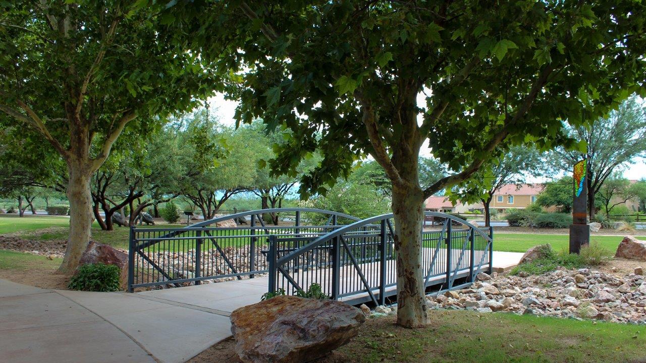 Welcome to The Madera, a beautifully expansive single-story new home nestled in the peaceful Sahuarita Acres community. With 2,131 square feet of thoughtfully arranged living space, this residence offers five bedrooms and three bathrooms, making it an exceptional choice for those who seek both comfort and versatility.  The journey through The Madera begins as you step onto the inviting front porch and enter through the welcoming foyer. The open layout immediately draws you into the spacious great room, where large windows allow natural light to fill the space, creating a warm and inviting atmosphere. The adjacent dining area flows seamlessly into the kitchen, which features a central island, quartz countertops, and 42” upper cabinets for ample storage. A walk-in pantry ensures that the kitchen remains both functional and stylish.  The Madera’s floor plan is designed with privacy in mind. The primary bedroom, located in a separate wing of the home, offers a large walk-in closet and an en-suite bathroom with dual sinks and a luxurious shower. On the opposite side of the home, four additional bedrooms are well-positioned to offer both privacy and easy access to the other two bathrooms, making this layout perfect for families or hosting guests.  One of the standout features of The Madera is its adaptability. The three-car garage and expansive near one-acre lots provide plenty of room for parking, storage, and outdoor activities, whether you envision creating a lush garden, installing a pool, or simply enjoying the vast open space.  For those who value modern conveniences, The Madera is equipped with D.R. Horton’s Home is Connected® Smart Home package, which includes a smart thermostat, video doorbell, keyless entry, a Wi-Fi-enabled garage door opener and more. Additionally, the home is built with energy efficiency in mind, featuring spray foam insulation and meeting DOE Zero Energy Ready Home standards, ensuring long-term savings and environmental benefits.  Located within the serene and spacious Sahuarita Acres community, residents of The Madera enjoy the perfect blend of small-town charm and modern amenities. With easy access to urban conveniences, excellent schools, and outdoor recreation opportunities, The Madera offers a lifestyle that embraces the essence of Arizona living.