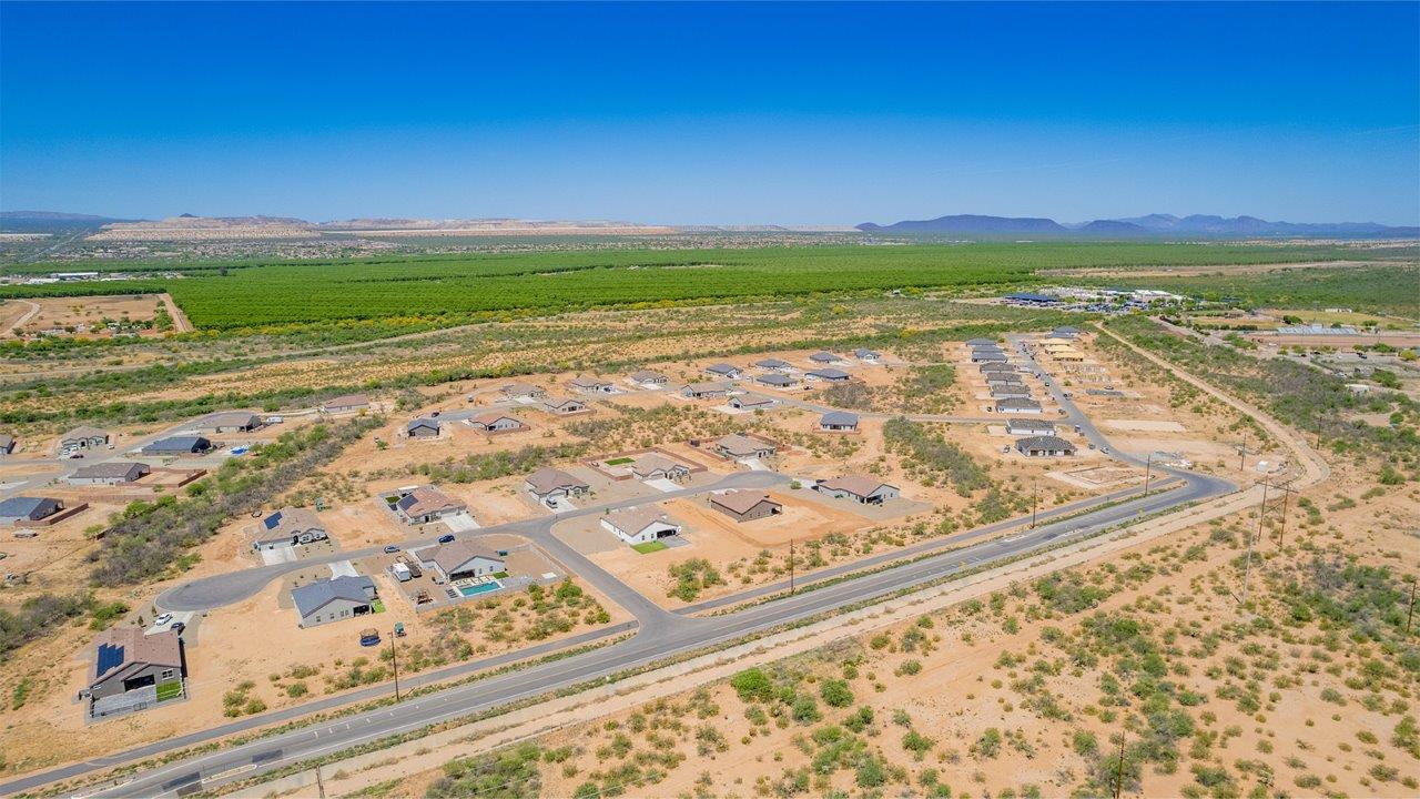 Welcome to The Madera, a beautifully expansive single-story new home nestled in the peaceful Sahuarita Acres community. With 2,131 square feet of thoughtfully arranged living space, this residence offers five bedrooms and three bathrooms, making it an exceptional choice for those who seek both comfort and versatility.  The journey through The Madera begins as you step onto the inviting front porch and enter through the welcoming foyer. The open layout immediately draws you into the spacious great room, where large windows allow natural light to fill the space, creating a warm and inviting atmosphere. The adjacent dining area flows seamlessly into the kitchen, which features a central island, quartz countertops, and 42” upper cabinets for ample storage. A walk-in pantry ensures that the kitchen remains both functional and stylish.  The Madera’s floor plan is designed with privacy in mind. The primary bedroom, located in a separate wing of the home, offers a large walk-in closet and an en-suite bathroom with dual sinks and a luxurious shower. On the opposite side of the home, four additional bedrooms are well-positioned to offer both privacy and easy access to the other two bathrooms, making this layout perfect for families or hosting guests.  One of the standout features of The Madera is its adaptability. The three-car garage and expansive near one-acre lots provide plenty of room for parking, storage, and outdoor activities, whether you envision creating a lush garden, installing a pool, or simply enjoying the vast open space.  For those who value modern conveniences, The Madera is equipped with D.R. Horton’s Home is Connected® Smart Home package, which includes a smart thermostat, video doorbell, keyless entry, a Wi-Fi-enabled garage door opener and more. Additionally, the home is built with energy efficiency in mind, featuring spray foam insulation and meeting DOE Zero Energy Ready Home standards, ensuring long-term savings and environmental benefits.  Located within the serene and spacious Sahuarita Acres community, residents of The Madera enjoy the perfect blend of small-town charm and modern amenities. With easy access to urban conveniences, excellent schools, and outdoor recreation opportunities, The Madera offers a lifestyle that embraces the essence of Arizona living.