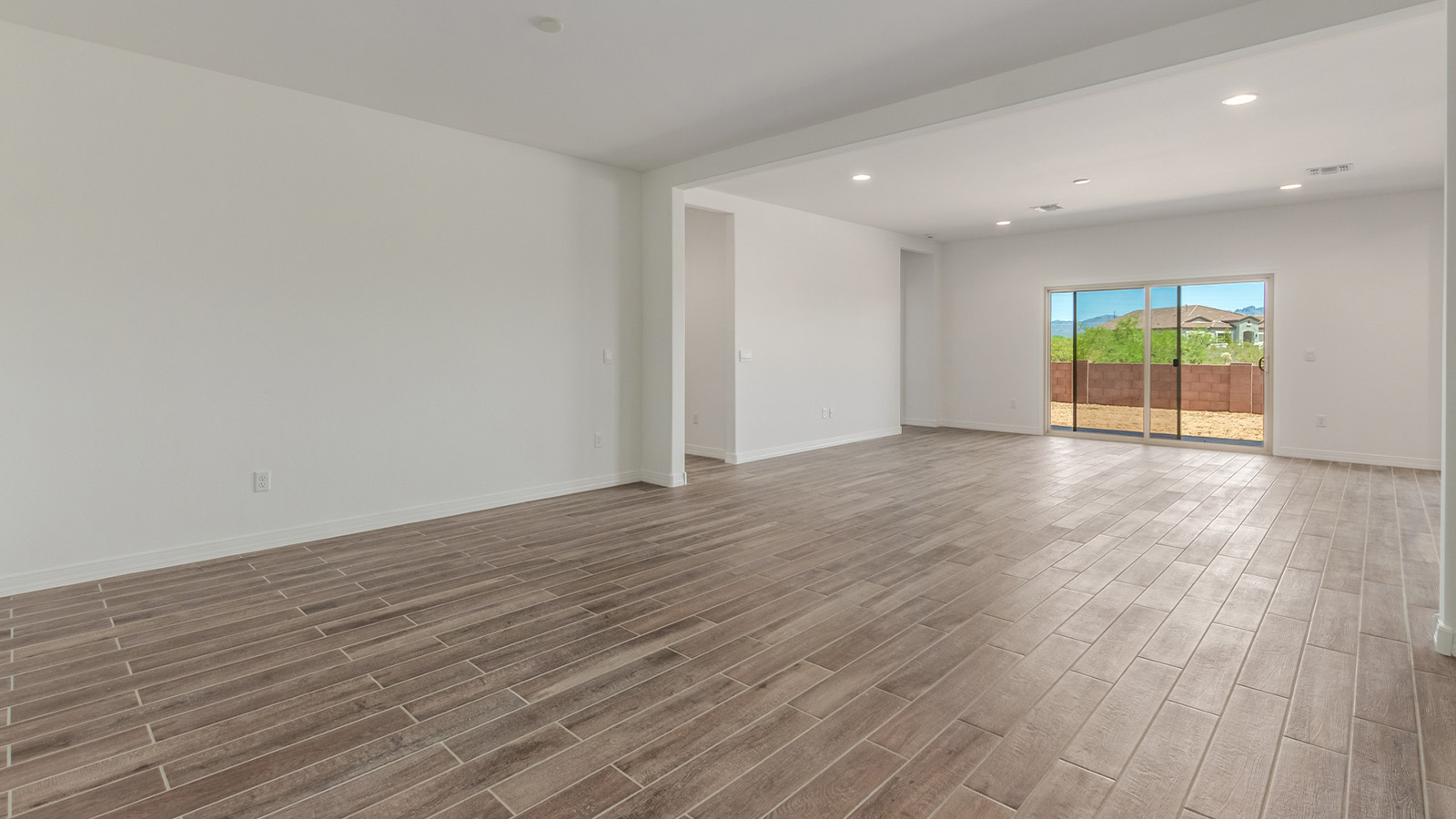 Introducing The Catalina, an expansive single-story home set in the serene and spacious Sahuarita Acres community. Covering 2,392 square feet, this residence offers four bedrooms and three bathrooms, perfectly balancing space and functionality for modern family living.  As you step into The Catalina, the entryway opens up to reveal a generous dining room that leads directly into the heart of the home—the great room. This central living space is designed for both relaxation and entertainment, with large windows that invite abundant natural light. The adjoining kitchen, complete with a large island, quartz countertops, and 42” upper cabinets, is as practical as it is stylish. A walk-in pantry provides ample storage, ensuring that everything you need is at your fingertips.  The primary bedroom, located in its own private wing, features a spacious walk-in closet and an en-suite bathroom equipped with dual sinks and a luxurious shower, offering a perfect space for winding down after a busy day. The additional three bedrooms are well-spaced throughout the home, each offering easy access to one of the two additional bathrooms, making it ideal for family living or hosting guests.  One of the standout features of The Catalina is its seamless blend of indoor and outdoor living. The covered patio, accessible from the great room, is an ideal spot for outdoor dining or simply enjoying the expansive one-acre lot that comes with each home in Sahuarita Acres. Whether you envision a garden, a play area, or even a pool, the possibilities are endless with the amount of outdoor space available.  The Catalina also includes a three-car garage and ample driveway space, perfect for parking vehicles, RVs, or additional storage. With D.R. Horton’s Home is Connected® Smart Home package, this home ensures you stay connected and secure, featuring a smart thermostat, video doorbell, keyless entry, a Wi-Fi-enabled garage door opener, and more.  Built with energy efficiency in mind, The Catalina features spray foam insulation and meets DOE Zero Energy Ready Home standards, helping you save on energy costs while contributing to a greener environment.  Nestled in the tranquil Sahuarita Acres community, residents enjoy the best of both worlds—peaceful, spacious living with easy access to urban amenities and outdoor recreation. With its combination of modern conveniences, thoughtful design, and expansive lots, The Catalina offers a lifestyle that truly captures the essence of Arizona living.