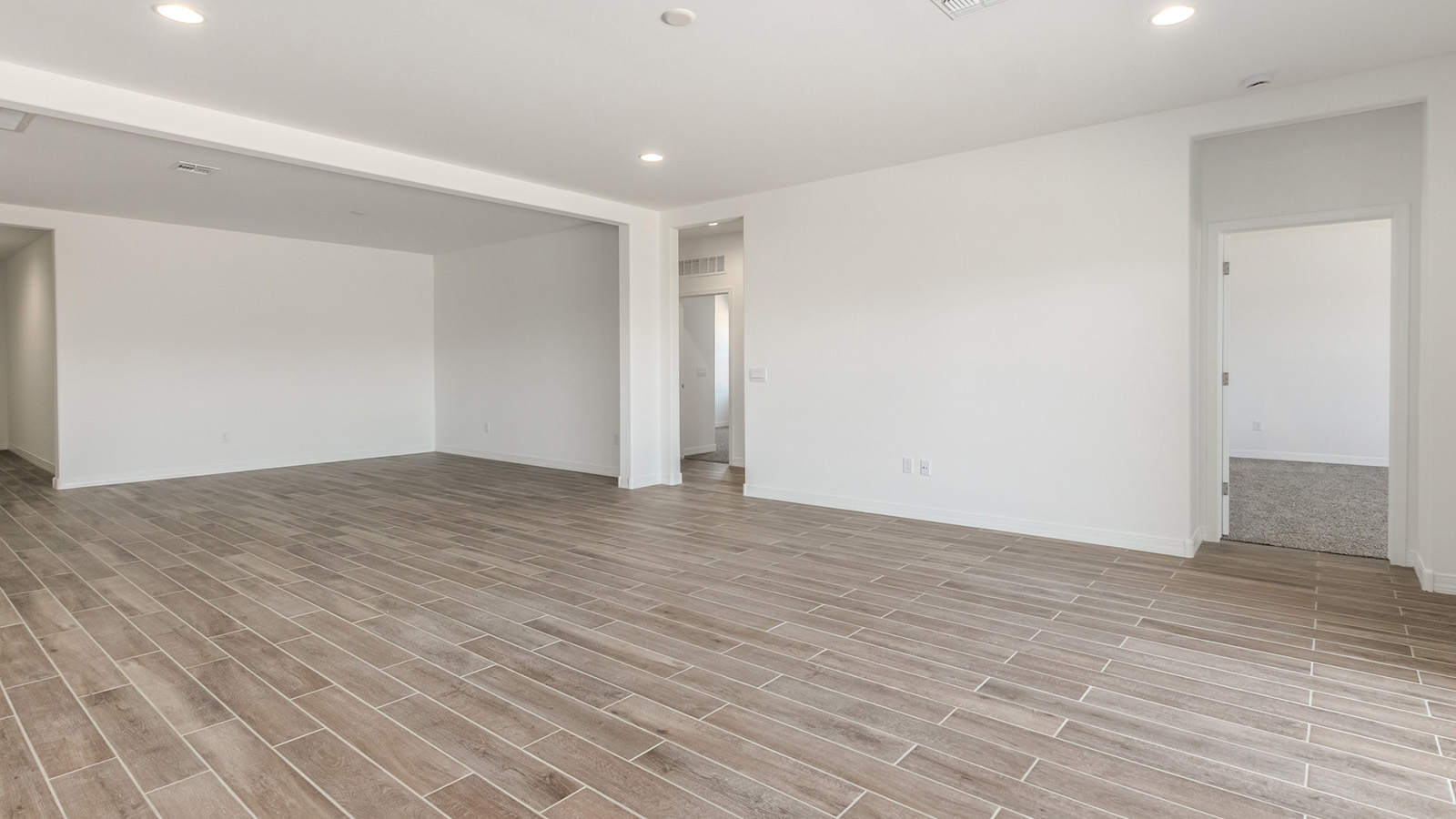 Introducing The Catalina, an expansive single-story home set in the serene and spacious Sahuarita Acres community. Covering 2,392 square feet, this residence offers four bedrooms and three bathrooms, perfectly balancing space and functionality for modern family living.  As you step into The Catalina, the entryway opens up to reveal a generous dining room that leads directly into the heart of the home—the great room. This central living space is designed for both relaxation and entertainment, with large windows that invite abundant natural light. The adjoining kitchen, complete with a large island, quartz countertops, and 42” upper cabinets, is as practical as it is stylish. A walk-in pantry provides ample storage, ensuring that everything you need is at your fingertips.  The primary bedroom, located in its own private wing, features a spacious walk-in closet and an en-suite bathroom equipped with dual sinks and a luxurious shower, offering a perfect space for winding down after a busy day. The additional three bedrooms are well-spaced throughout the home, each offering easy access to one of the two additional bathrooms, making it ideal for family living or hosting guests.  One of the standout features of The Catalina is its seamless blend of indoor and outdoor living. The covered patio, accessible from the great room, is an ideal spot for outdoor dining or simply enjoying the expansive one-acre lot that comes with each home in Sahuarita Acres. Whether you envision a garden, a play area, or even a pool, the possibilities are endless with the amount of outdoor space available.  The Catalina also includes a three-car garage and ample driveway space, perfect for parking vehicles, RVs, or additional storage. With D.R. Horton’s Home is Connected® Smart Home package, this home ensures you stay connected and secure, featuring a smart thermostat, video doorbell, keyless entry, a Wi-Fi-enabled garage door opener, and more.  Built with energy efficiency in mind, The Catalina features spray foam insulation and meets DOE Zero Energy Ready Home standards, helping you save on energy costs while contributing to a greener environment.  Nestled in the tranquil Sahuarita Acres community, residents enjoy the best of both worlds—peaceful, spacious living with easy access to urban amenities and outdoor recreation. With its combination of modern conveniences, thoughtful design, and expansive lots, The Catalina offers a lifestyle that truly captures the essence of Arizona living.