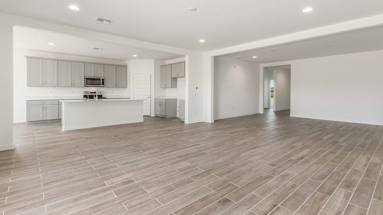 Introducing The Catalina, an expansive single-story home set in the serene and spacious Sahuarita Acres community. Covering 2,392 square feet, this residence offers four bedrooms and three bathrooms, perfectly balancing space and functionality for modern family living.  As you step into The Catalina, the entryway opens up to reveal a generous dining room that leads directly into the heart of the home—the great room. This central living space is designed for both relaxation and entertainment, with large windows that invite abundant natural light. The adjoining kitchen, complete with a large island, quartz countertops, and 42” upper cabinets, is as practical as it is stylish. A walk-in pantry provides ample storage, ensuring that everything you need is at your fingertips.  The primary bedroom, located in its own private wing, features a spacious walk-in closet and an en-suite bathroom equipped with dual sinks and a luxurious shower, offering a perfect space for winding down after a busy day. The additional three bedrooms are well-spaced throughout the home, each offering easy access to one of the two additional bathrooms, making it ideal for family living or hosting guests.  One of the standout features of The Catalina is its seamless blend of indoor and outdoor living. The covered patio, accessible from the great room, is an ideal spot for outdoor dining or simply enjoying the expansive one-acre lot that comes with each home in Sahuarita Acres. Whether you envision a garden, a play area, or even a pool, the possibilities are endless with the amount of outdoor space available.  The Catalina also includes a three-car garage and ample driveway space, perfect for parking vehicles, RVs, or additional storage. With D.R. Horton’s Home is Connected® Smart Home package, this home ensures you stay connected and secure, featuring a smart thermostat, video doorbell, keyless entry, a Wi-Fi-enabled garage door opener, and more.  Built with energy efficiency in mind, The Catalina features spray foam insulation and meets DOE Zero Energy Ready Home standards, helping you save on energy costs while contributing to a greener environment.  Nestled in the tranquil Sahuarita Acres community, residents enjoy the best of both worlds—peaceful, spacious living with easy access to urban amenities and outdoor recreation. With its combination of modern conveniences, thoughtful design, and expansive lots, The Catalina offers a lifestyle that truly captures the essence of Arizona living.