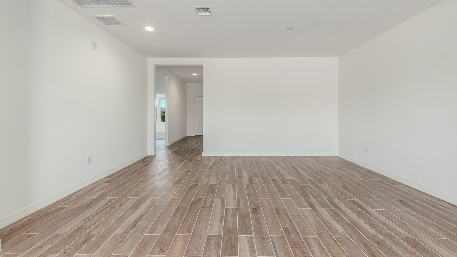 Introducing The Catalina, an expansive single-story home set in the serene and spacious Sahuarita Acres community. Covering 2,392 square feet, this residence offers four bedrooms and three bathrooms, perfectly balancing space and functionality for modern family living.  As you step into The Catalina, the entryway opens up to reveal a generous dining room that leads directly into the heart of the home—the great room. This central living space is designed for both relaxation and entertainment, with large windows that invite abundant natural light. The adjoining kitchen, complete with a large island, quartz countertops, and 42” upper cabinets, is as practical as it is stylish. A walk-in pantry provides ample storage, ensuring that everything you need is at your fingertips.  The primary bedroom, located in its own private wing, features a spacious walk-in closet and an en-suite bathroom equipped with dual sinks and a luxurious shower, offering a perfect space for winding down after a busy day. The additional three bedrooms are well-spaced throughout the home, each offering easy access to one of the two additional bathrooms, making it ideal for family living or hosting guests.  One of the standout features of The Catalina is its seamless blend of indoor and outdoor living. The covered patio, accessible from the great room, is an ideal spot for outdoor dining or simply enjoying the expansive one-acre lot that comes with each home in Sahuarita Acres. Whether you envision a garden, a play area, or even a pool, the possibilities are endless with the amount of outdoor space available.  The Catalina also includes a three-car garage and ample driveway space, perfect for parking vehicles, RVs, or additional storage. With D.R. Horton’s Home is Connected® Smart Home package, this home ensures you stay connected and secure, featuring a smart thermostat, video doorbell, keyless entry, a Wi-Fi-enabled garage door opener, and more.  Built with energy efficiency in mind, The Catalina features spray foam insulation and meets DOE Zero Energy Ready Home standards, helping you save on energy costs while contributing to a greener environment.  Nestled in the tranquil Sahuarita Acres community, residents enjoy the best of both worlds—peaceful, spacious living with easy access to urban amenities and outdoor recreation. With its combination of modern conveniences, thoughtful design, and expansive lots, The Catalina offers a lifestyle that truly captures the essence of Arizona living.