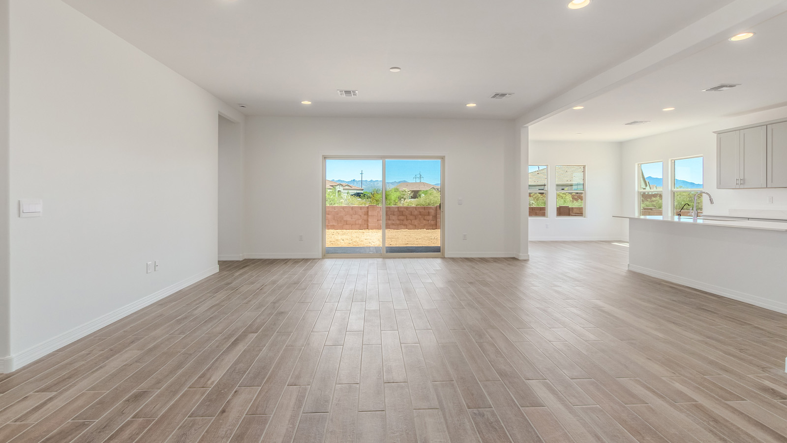 Introducing The Catalina, an expansive single-story home set in the serene and spacious Sahuarita Acres community. Covering 2,392 square feet, this residence offers four bedrooms and three bathrooms, perfectly balancing space and functionality for modern family living.  As you step into The Catalina, the entryway opens up to reveal a generous dining room that leads directly into the heart of the home—the great room. This central living space is designed for both relaxation and entertainment, with large windows that invite abundant natural light. The adjoining kitchen, complete with a large island, quartz countertops, and 42” upper cabinets, is as practical as it is stylish. A walk-in pantry provides ample storage, ensuring that everything you need is at your fingertips.  The primary bedroom, located in its own private wing, features a spacious walk-in closet and an en-suite bathroom equipped with dual sinks and a luxurious shower, offering a perfect space for winding down after a busy day. The additional three bedrooms are well-spaced throughout the home, each offering easy access to one of the two additional bathrooms, making it ideal for family living or hosting guests.  One of the standout features of The Catalina is its seamless blend of indoor and outdoor living. The covered patio, accessible from the great room, is an ideal spot for outdoor dining or simply enjoying the expansive one-acre lot that comes with each home in Sahuarita Acres. Whether you envision a garden, a play area, or even a pool, the possibilities are endless with the amount of outdoor space available.  The Catalina also includes a three-car garage and ample driveway space, perfect for parking vehicles, RVs, or additional storage. With D.R. Horton’s Home is Connected® Smart Home package, this home ensures you stay connected and secure, featuring a smart thermostat, video doorbell, keyless entry, a Wi-Fi-enabled garage door opener, and more.  Built with energy efficiency in mind, The Catalina features spray foam insulation and meets DOE Zero Energy Ready Home standards, helping you save on energy costs while contributing to a greener environment.  Nestled in the tranquil Sahuarita Acres community, residents enjoy the best of both worlds—peaceful, spacious living with easy access to urban amenities and outdoor recreation. With its combination of modern conveniences, thoughtful design, and expansive lots, The Catalina offers a lifestyle that truly captures the essence of Arizona living.