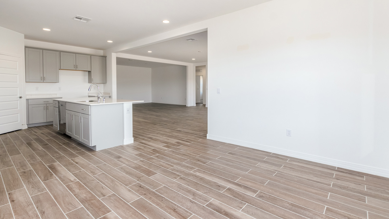 Introducing The Catalina, an expansive single-story home set in the serene and spacious Sahuarita Acres community. Covering 2,392 square feet, this residence offers four bedrooms and three bathrooms, perfectly balancing space and functionality for modern family living.  As you step into The Catalina, the entryway opens up to reveal a generous dining room that leads directly into the heart of the home—the great room. This central living space is designed for both relaxation and entertainment, with large windows that invite abundant natural light. The adjoining kitchen, complete with a large island, quartz countertops, and 42” upper cabinets, is as practical as it is stylish. A walk-in pantry provides ample storage, ensuring that everything you need is at your fingertips.  The primary bedroom, located in its own private wing, features a spacious walk-in closet and an en-suite bathroom equipped with dual sinks and a luxurious shower, offering a perfect space for winding down after a busy day. The additional three bedrooms are well-spaced throughout the home, each offering easy access to one of the two additional bathrooms, making it ideal for family living or hosting guests.  One of the standout features of The Catalina is its seamless blend of indoor and outdoor living. The covered patio, accessible from the great room, is an ideal spot for outdoor dining or simply enjoying the expansive one-acre lot that comes with each home in Sahuarita Acres. Whether you envision a garden, a play area, or even a pool, the possibilities are endless with the amount of outdoor space available.  The Catalina also includes a three-car garage and ample driveway space, perfect for parking vehicles, RVs, or additional storage. With D.R. Horton’s Home is Connected® Smart Home package, this home ensures you stay connected and secure, featuring a smart thermostat, video doorbell, keyless entry, a Wi-Fi-enabled garage door opener, and more.  Built with energy efficiency in mind, The Catalina features spray foam insulation and meets DOE Zero Energy Ready Home standards, helping you save on energy costs while contributing to a greener environment.  Nestled in the tranquil Sahuarita Acres community, residents enjoy the best of both worlds—peaceful, spacious living with easy access to urban amenities and outdoor recreation. With its combination of modern conveniences, thoughtful design, and expansive lots, The Catalina offers a lifestyle that truly captures the essence of Arizona living.