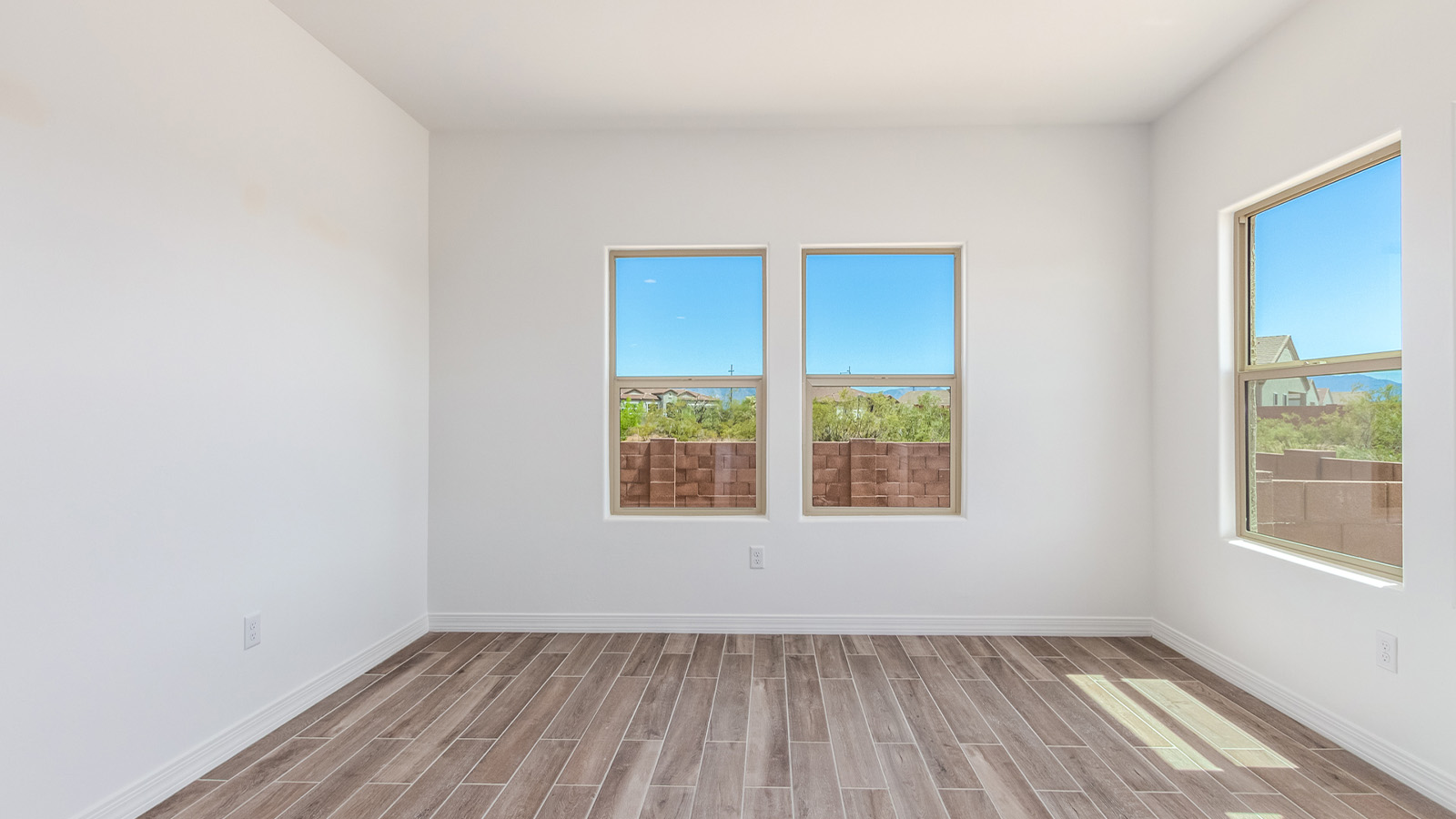 Introducing The Catalina, an expansive single-story home set in the serene and spacious Sahuarita Acres community. Covering 2,392 square feet, this residence offers four bedrooms and three bathrooms, perfectly balancing space and functionality for modern family living.  As you step into The Catalina, the entryway opens up to reveal a generous dining room that leads directly into the heart of the home—the great room. This central living space is designed for both relaxation and entertainment, with large windows that invite abundant natural light. The adjoining kitchen, complete with a large island, quartz countertops, and 42” upper cabinets, is as practical as it is stylish. A walk-in pantry provides ample storage, ensuring that everything you need is at your fingertips.  The primary bedroom, located in its own private wing, features a spacious walk-in closet and an en-suite bathroom equipped with dual sinks and a luxurious shower, offering a perfect space for winding down after a busy day. The additional three bedrooms are well-spaced throughout the home, each offering easy access to one of the two additional bathrooms, making it ideal for family living or hosting guests.  One of the standout features of The Catalina is its seamless blend of indoor and outdoor living. The covered patio, accessible from the great room, is an ideal spot for outdoor dining or simply enjoying the expansive one-acre lot that comes with each home in Sahuarita Acres. Whether you envision a garden, a play area, or even a pool, the possibilities are endless with the amount of outdoor space available.  The Catalina also includes a three-car garage and ample driveway space, perfect for parking vehicles, RVs, or additional storage. With D.R. Horton’s Home is Connected® Smart Home package, this home ensures you stay connected and secure, featuring a smart thermostat, video doorbell, keyless entry, a Wi-Fi-enabled garage door opener, and more.  Built with energy efficiency in mind, The Catalina features spray foam insulation and meets DOE Zero Energy Ready Home standards, helping you save on energy costs while contributing to a greener environment.  Nestled in the tranquil Sahuarita Acres community, residents enjoy the best of both worlds—peaceful, spacious living with easy access to urban amenities and outdoor recreation. With its combination of modern conveniences, thoughtful design, and expansive lots, The Catalina offers a lifestyle that truly captures the essence of Arizona living.