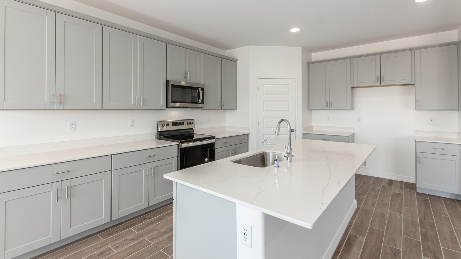 Introducing The Catalina, an expansive single-story home set in the serene and spacious Sahuarita Acres community. Covering 2,392 square feet, this residence offers four bedrooms and three bathrooms, perfectly balancing space and functionality for modern family living.  As you step into The Catalina, the entryway opens up to reveal a generous dining room that leads directly into the heart of the home—the great room. This central living space is designed for both relaxation and entertainment, with large windows that invite abundant natural light. The adjoining kitchen, complete with a large island, quartz countertops, and 42” upper cabinets, is as practical as it is stylish. A walk-in pantry provides ample storage, ensuring that everything you need is at your fingertips.  The primary bedroom, located in its own private wing, features a spacious walk-in closet and an en-suite bathroom equipped with dual sinks and a luxurious shower, offering a perfect space for winding down after a busy day. The additional three bedrooms are well-spaced throughout the home, each offering easy access to one of the two additional bathrooms, making it ideal for family living or hosting guests.  One of the standout features of The Catalina is its seamless blend of indoor and outdoor living. The covered patio, accessible from the great room, is an ideal spot for outdoor dining or simply enjoying the expansive one-acre lot that comes with each home in Sahuarita Acres. Whether you envision a garden, a play area, or even a pool, the possibilities are endless with the amount of outdoor space available.  The Catalina also includes a three-car garage and ample driveway space, perfect for parking vehicles, RVs, or additional storage. With D.R. Horton’s Home is Connected® Smart Home package, this home ensures you stay connected and secure, featuring a smart thermostat, video doorbell, keyless entry, a Wi-Fi-enabled garage door opener, and more.  Built with energy efficiency in mind, The Catalina features spray foam insulation and meets DOE Zero Energy Ready Home standards, helping you save on energy costs while contributing to a greener environment.  Nestled in the tranquil Sahuarita Acres community, residents enjoy the best of both worlds—peaceful, spacious living with easy access to urban amenities and outdoor recreation. With its combination of modern conveniences, thoughtful design, and expansive lots, The Catalina offers a lifestyle that truly captures the essence of Arizona living.