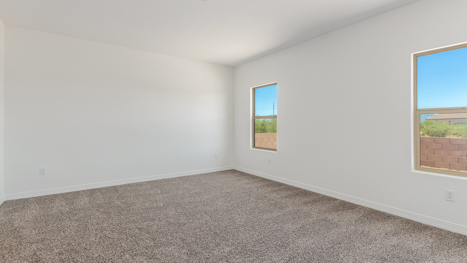 Introducing The Catalina, an expansive single-story home set in the serene and spacious Sahuarita Acres community. Covering 2,392 square feet, this residence offers four bedrooms and three bathrooms, perfectly balancing space and functionality for modern family living.  As you step into The Catalina, the entryway opens up to reveal a generous dining room that leads directly into the heart of the home—the great room. This central living space is designed for both relaxation and entertainment, with large windows that invite abundant natural light. The adjoining kitchen, complete with a large island, quartz countertops, and 42” upper cabinets, is as practical as it is stylish. A walk-in pantry provides ample storage, ensuring that everything you need is at your fingertips.  The primary bedroom, located in its own private wing, features a spacious walk-in closet and an en-suite bathroom equipped with dual sinks and a luxurious shower, offering a perfect space for winding down after a busy day. The additional three bedrooms are well-spaced throughout the home, each offering easy access to one of the two additional bathrooms, making it ideal for family living or hosting guests.  One of the standout features of The Catalina is its seamless blend of indoor and outdoor living. The covered patio, accessible from the great room, is an ideal spot for outdoor dining or simply enjoying the expansive one-acre lot that comes with each home in Sahuarita Acres. Whether you envision a garden, a play area, or even a pool, the possibilities are endless with the amount of outdoor space available.  The Catalina also includes a three-car garage and ample driveway space, perfect for parking vehicles, RVs, or additional storage. With D.R. Horton’s Home is Connected® Smart Home package, this home ensures you stay connected and secure, featuring a smart thermostat, video doorbell, keyless entry, a Wi-Fi-enabled garage door opener, and more.  Built with energy efficiency in mind, The Catalina features spray foam insulation and meets DOE Zero Energy Ready Home standards, helping you save on energy costs while contributing to a greener environment.  Nestled in the tranquil Sahuarita Acres community, residents enjoy the best of both worlds—peaceful, spacious living with easy access to urban amenities and outdoor recreation. With its combination of modern conveniences, thoughtful design, and expansive lots, The Catalina offers a lifestyle that truly captures the essence of Arizona living.