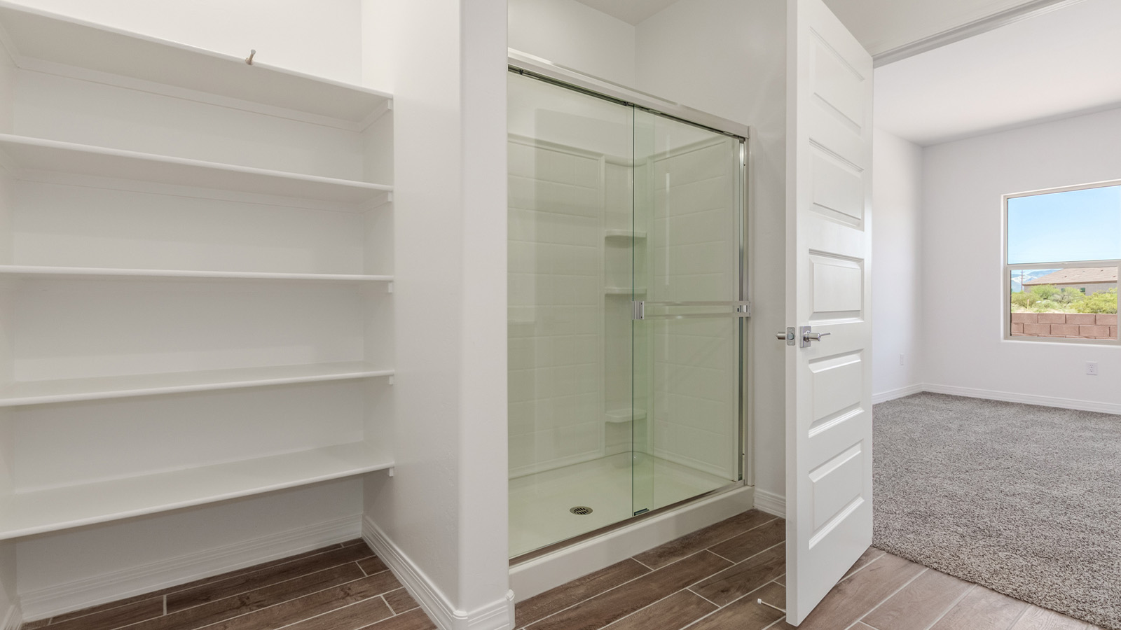 Introducing The Catalina, an expansive single-story home set in the serene and spacious Sahuarita Acres community. Covering 2,392 square feet, this residence offers four bedrooms and three bathrooms, perfectly balancing space and functionality for modern family living.  As you step into The Catalina, the entryway opens up to reveal a generous dining room that leads directly into the heart of the home—the great room. This central living space is designed for both relaxation and entertainment, with large windows that invite abundant natural light. The adjoining kitchen, complete with a large island, quartz countertops, and 42” upper cabinets, is as practical as it is stylish. A walk-in pantry provides ample storage, ensuring that everything you need is at your fingertips.  The primary bedroom, located in its own private wing, features a spacious walk-in closet and an en-suite bathroom equipped with dual sinks and a luxurious shower, offering a perfect space for winding down after a busy day. The additional three bedrooms are well-spaced throughout the home, each offering easy access to one of the two additional bathrooms, making it ideal for family living or hosting guests.  One of the standout features of The Catalina is its seamless blend of indoor and outdoor living. The covered patio, accessible from the great room, is an ideal spot for outdoor dining or simply enjoying the expansive one-acre lot that comes with each home in Sahuarita Acres. Whether you envision a garden, a play area, or even a pool, the possibilities are endless with the amount of outdoor space available.  The Catalina also includes a three-car garage and ample driveway space, perfect for parking vehicles, RVs, or additional storage. With D.R. Horton’s Home is Connected® Smart Home package, this home ensures you stay connected and secure, featuring a smart thermostat, video doorbell, keyless entry, a Wi-Fi-enabled garage door opener, and more.  Built with energy efficiency in mind, The Catalina features spray foam insulation and meets DOE Zero Energy Ready Home standards, helping you save on energy costs while contributing to a greener environment.  Nestled in the tranquil Sahuarita Acres community, residents enjoy the best of both worlds—peaceful, spacious living with easy access to urban amenities and outdoor recreation. With its combination of modern conveniences, thoughtful design, and expansive lots, The Catalina offers a lifestyle that truly captures the essence of Arizona living.