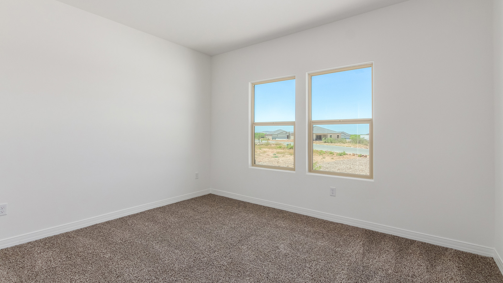 Introducing The Catalina, an expansive single-story home set in the serene and spacious Sahuarita Acres community. Covering 2,392 square feet, this residence offers four bedrooms and three bathrooms, perfectly balancing space and functionality for modern family living.  As you step into The Catalina, the entryway opens up to reveal a generous dining room that leads directly into the heart of the home—the great room. This central living space is designed for both relaxation and entertainment, with large windows that invite abundant natural light. The adjoining kitchen, complete with a large island, quartz countertops, and 42” upper cabinets, is as practical as it is stylish. A walk-in pantry provides ample storage, ensuring that everything you need is at your fingertips.  The primary bedroom, located in its own private wing, features a spacious walk-in closet and an en-suite bathroom equipped with dual sinks and a luxurious shower, offering a perfect space for winding down after a busy day. The additional three bedrooms are well-spaced throughout the home, each offering easy access to one of the two additional bathrooms, making it ideal for family living or hosting guests.  One of the standout features of The Catalina is its seamless blend of indoor and outdoor living. The covered patio, accessible from the great room, is an ideal spot for outdoor dining or simply enjoying the expansive one-acre lot that comes with each home in Sahuarita Acres. Whether you envision a garden, a play area, or even a pool, the possibilities are endless with the amount of outdoor space available.  The Catalina also includes a three-car garage and ample driveway space, perfect for parking vehicles, RVs, or additional storage. With D.R. Horton’s Home is Connected® Smart Home package, this home ensures you stay connected and secure, featuring a smart thermostat, video doorbell, keyless entry, a Wi-Fi-enabled garage door opener, and more.  Built with energy efficiency in mind, The Catalina features spray foam insulation and meets DOE Zero Energy Ready Home standards, helping you save on energy costs while contributing to a greener environment.  Nestled in the tranquil Sahuarita Acres community, residents enjoy the best of both worlds—peaceful, spacious living with easy access to urban amenities and outdoor recreation. With its combination of modern conveniences, thoughtful design, and expansive lots, The Catalina offers a lifestyle that truly captures the essence of Arizona living.