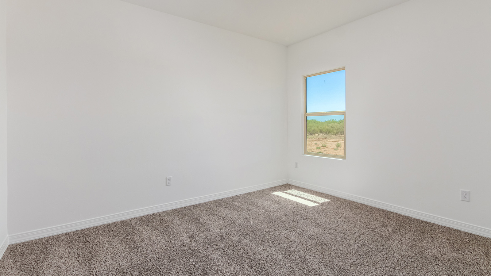 Introducing The Catalina, an expansive single-story home set in the serene and spacious Sahuarita Acres community. Covering 2,392 square feet, this residence offers four bedrooms and three bathrooms, perfectly balancing space and functionality for modern family living.  As you step into The Catalina, the entryway opens up to reveal a generous dining room that leads directly into the heart of the home—the great room. This central living space is designed for both relaxation and entertainment, with large windows that invite abundant natural light. The adjoining kitchen, complete with a large island, quartz countertops, and 42” upper cabinets, is as practical as it is stylish. A walk-in pantry provides ample storage, ensuring that everything you need is at your fingertips.  The primary bedroom, located in its own private wing, features a spacious walk-in closet and an en-suite bathroom equipped with dual sinks and a luxurious shower, offering a perfect space for winding down after a busy day. The additional three bedrooms are well-spaced throughout the home, each offering easy access to one of the two additional bathrooms, making it ideal for family living or hosting guests.  One of the standout features of The Catalina is its seamless blend of indoor and outdoor living. The covered patio, accessible from the great room, is an ideal spot for outdoor dining or simply enjoying the expansive one-acre lot that comes with each home in Sahuarita Acres. Whether you envision a garden, a play area, or even a pool, the possibilities are endless with the amount of outdoor space available.  The Catalina also includes a three-car garage and ample driveway space, perfect for parking vehicles, RVs, or additional storage. With D.R. Horton’s Home is Connected® Smart Home package, this home ensures you stay connected and secure, featuring a smart thermostat, video doorbell, keyless entry, a Wi-Fi-enabled garage door opener, and more.  Built with energy efficiency in mind, The Catalina features spray foam insulation and meets DOE Zero Energy Ready Home standards, helping you save on energy costs while contributing to a greener environment.  Nestled in the tranquil Sahuarita Acres community, residents enjoy the best of both worlds—peaceful, spacious living with easy access to urban amenities and outdoor recreation. With its combination of modern conveniences, thoughtful design, and expansive lots, The Catalina offers a lifestyle that truly captures the essence of Arizona living.