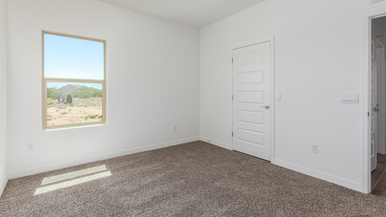 Introducing The Catalina, an expansive single-story home set in the serene and spacious Sahuarita Acres community. Covering 2,392 square feet, this residence offers four bedrooms and three bathrooms, perfectly balancing space and functionality for modern family living.  As you step into The Catalina, the entryway opens up to reveal a generous dining room that leads directly into the heart of the home—the great room. This central living space is designed for both relaxation and entertainment, with large windows that invite abundant natural light. The adjoining kitchen, complete with a large island, quartz countertops, and 42” upper cabinets, is as practical as it is stylish. A walk-in pantry provides ample storage, ensuring that everything you need is at your fingertips.  The primary bedroom, located in its own private wing, features a spacious walk-in closet and an en-suite bathroom equipped with dual sinks and a luxurious shower, offering a perfect space for winding down after a busy day. The additional three bedrooms are well-spaced throughout the home, each offering easy access to one of the two additional bathrooms, making it ideal for family living or hosting guests.  One of the standout features of The Catalina is its seamless blend of indoor and outdoor living. The covered patio, accessible from the great room, is an ideal spot for outdoor dining or simply enjoying the expansive one-acre lot that comes with each home in Sahuarita Acres. Whether you envision a garden, a play area, or even a pool, the possibilities are endless with the amount of outdoor space available.  The Catalina also includes a three-car garage and ample driveway space, perfect for parking vehicles, RVs, or additional storage. With D.R. Horton’s Home is Connected® Smart Home package, this home ensures you stay connected and secure, featuring a smart thermostat, video doorbell, keyless entry, a Wi-Fi-enabled garage door opener, and more.  Built with energy efficiency in mind, The Catalina features spray foam insulation and meets DOE Zero Energy Ready Home standards, helping you save on energy costs while contributing to a greener environment.  Nestled in the tranquil Sahuarita Acres community, residents enjoy the best of both worlds—peaceful, spacious living with easy access to urban amenities and outdoor recreation. With its combination of modern conveniences, thoughtful design, and expansive lots, The Catalina offers a lifestyle that truly captures the essence of Arizona living.