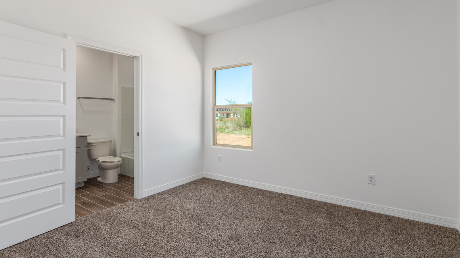 Introducing The Catalina, an expansive single-story home set in the serene and spacious Sahuarita Acres community. Covering 2,392 square feet, this residence offers four bedrooms and three bathrooms, perfectly balancing space and functionality for modern family living.  As you step into The Catalina, the entryway opens up to reveal a generous dining room that leads directly into the heart of the home—the great room. This central living space is designed for both relaxation and entertainment, with large windows that invite abundant natural light. The adjoining kitchen, complete with a large island, quartz countertops, and 42” upper cabinets, is as practical as it is stylish. A walk-in pantry provides ample storage, ensuring that everything you need is at your fingertips.  The primary bedroom, located in its own private wing, features a spacious walk-in closet and an en-suite bathroom equipped with dual sinks and a luxurious shower, offering a perfect space for winding down after a busy day. The additional three bedrooms are well-spaced throughout the home, each offering easy access to one of the two additional bathrooms, making it ideal for family living or hosting guests.  One of the standout features of The Catalina is its seamless blend of indoor and outdoor living. The covered patio, accessible from the great room, is an ideal spot for outdoor dining or simply enjoying the expansive one-acre lot that comes with each home in Sahuarita Acres. Whether you envision a garden, a play area, or even a pool, the possibilities are endless with the amount of outdoor space available.  The Catalina also includes a three-car garage and ample driveway space, perfect for parking vehicles, RVs, or additional storage. With D.R. Horton’s Home is Connected® Smart Home package, this home ensures you stay connected and secure, featuring a smart thermostat, video doorbell, keyless entry, a Wi-Fi-enabled garage door opener, and more.  Built with energy efficiency in mind, The Catalina features spray foam insulation and meets DOE Zero Energy Ready Home standards, helping you save on energy costs while contributing to a greener environment.  Nestled in the tranquil Sahuarita Acres community, residents enjoy the best of both worlds—peaceful, spacious living with easy access to urban amenities and outdoor recreation. With its combination of modern conveniences, thoughtful design, and expansive lots, The Catalina offers a lifestyle that truly captures the essence of Arizona living.