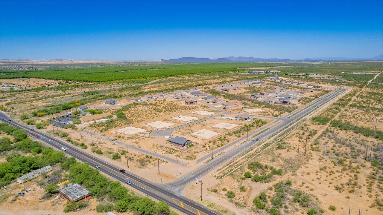 Introducing The Catalina, an expansive single-story home set in the serene and spacious Sahuarita Acres community. Covering 2,392 square feet, this residence offers four bedrooms and three bathrooms, perfectly balancing space and functionality for modern family living.  As you step into The Catalina, the entryway opens up to reveal a generous dining room that leads directly into the heart of the home—the great room. This central living space is designed for both relaxation and entertainment, with large windows that invite abundant natural light. The adjoining kitchen, complete with a large island, quartz countertops, and 42” upper cabinets, is as practical as it is stylish. A walk-in pantry provides ample storage, ensuring that everything you need is at your fingertips.  The primary bedroom, located in its own private wing, features a spacious walk-in closet and an en-suite bathroom equipped with dual sinks and a luxurious shower, offering a perfect space for winding down after a busy day. The additional three bedrooms are well-spaced throughout the home, each offering easy access to one of the two additional bathrooms, making it ideal for family living or hosting guests.  One of the standout features of The Catalina is its seamless blend of indoor and outdoor living. The covered patio, accessible from the great room, is an ideal spot for outdoor dining or simply enjoying the expansive one-acre lot that comes with each home in Sahuarita Acres. Whether you envision a garden, a play area, or even a pool, the possibilities are endless with the amount of outdoor space available.  The Catalina also includes a three-car garage and ample driveway space, perfect for parking vehicles, RVs, or additional storage. With D.R. Horton’s Home is Connected® Smart Home package, this home ensures you stay connected and secure, featuring a smart thermostat, video doorbell, keyless entry, a Wi-Fi-enabled garage door opener, and more.  Built with energy efficiency in mind, The Catalina features spray foam insulation and meets DOE Zero Energy Ready Home standards, helping you save on energy costs while contributing to a greener environment.  Nestled in the tranquil Sahuarita Acres community, residents enjoy the best of both worlds—peaceful, spacious living with easy access to urban amenities and outdoor recreation. With its combination of modern conveniences, thoughtful design, and expansive lots, The Catalina offers a lifestyle that truly captures the essence of Arizona living.
