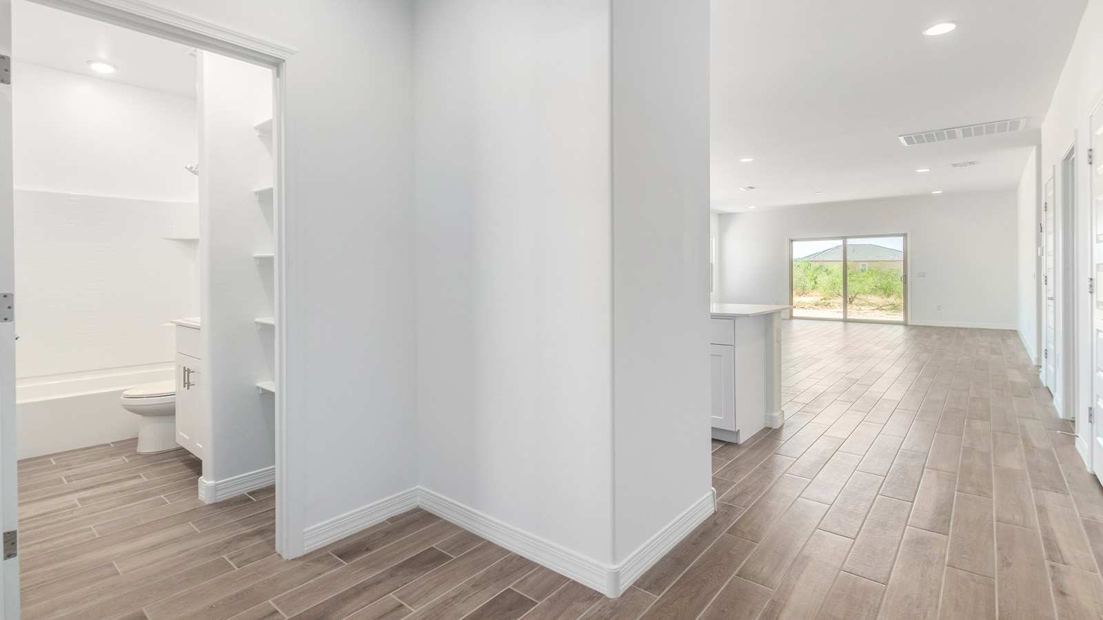 Welcome to The Sedona, a spacious and elegant single-story new home nestled in the expansive Sahuarita Acres community. Offering 2,530 square feet of living space, this home features five bedrooms and three bathrooms, designed to accommodate both comfort and functionality for modern family living.  As you step through the charming front porch, you are greeted by an inviting entryway that opens into a thoughtfully arranged interior. The heart of the home is the expansive great room, which seamlessly connects to the dining area and kitchen. This open-concept layout is perfect for those who enjoy entertaining or simply want a space where family life can flow naturally. The kitchen is a culinary haven, featuring a large island, sleek quartz countertops, and ample 42” upper cabinets for all your storage needs. A walk-in pantry ensures that your kitchen remains organized and efficient.  The primary bedroom is situated in its own private wing, offering a spacious walk-in closet and an en-suite bathroom with dual sinks and a luxurious shower. This room is designed as a peaceful haven, providing the perfect space to unwind at the end of the day. The additional four bedrooms are well-positioned within the home, each with easy access to one of the two additional bathrooms, making this layout ideal for families or hosting guests.  Outdoor living is a highlight of The Sedona, with a covered patio that extends from the great room, offering a seamless transition between indoor and outdoor spaces. Whether you envision hosting summer barbecues or simply enjoying the tranquility of your expansive one-acre lot, this outdoor space is perfect for creating your ideal backyard oasis.  Practical features of The Sedona include a three-car garage, which provides ample space for vehicles, storage, or even a workshop. The utility room is conveniently located near the kitchen, making household chores more manageable.  In line with modern living, The Sedona is equipped with D.R. Horton’s Home is Connected® Smart Home package, which includes a smart thermostat, video doorbell, keyless entry, a Wi-Fi-enabled garage door opener and more. The home is also designed with energy efficiency in mind, featuring spray foam insulation and meeting DOE Zero Energy Ready Home standards, ensuring long-term savings and environmental benefits.  Located within the peaceful Sahuarita Acres community, The Sedona offers residents the best of both worlds—spacious living with the conveniences of nearby urban amenities. Just 30 minutes from downtown Tucson and close to local attractions like the Titan Missile Museum and Madera Canyon, this home offers a lifestyle that embraces the essence of Arizona living.