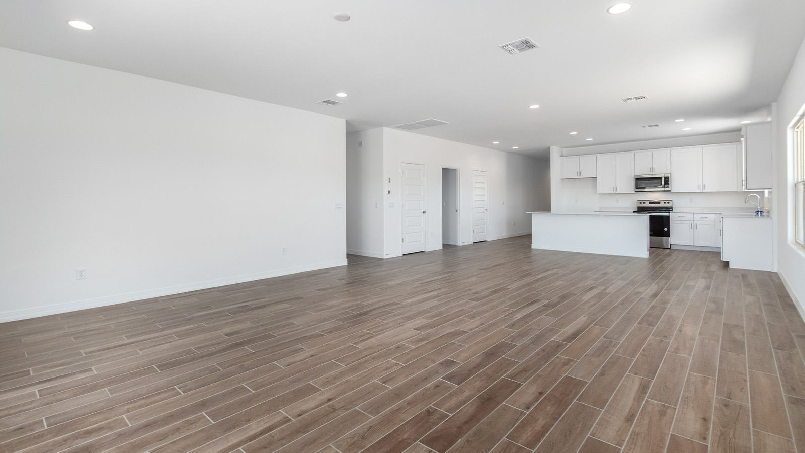 Welcome to The Sedona, a spacious and elegant single-story new home nestled in the expansive Sahuarita Acres community. Offering 2,530 square feet of living space, this home features five bedrooms and three bathrooms, designed to accommodate both comfort and functionality for modern family living.  As you step through the charming front porch, you are greeted by an inviting entryway that opens into a thoughtfully arranged interior. The heart of the home is the expansive great room, which seamlessly connects to the dining area and kitchen. This open-concept layout is perfect for those who enjoy entertaining or simply want a space where family life can flow naturally. The kitchen is a culinary haven, featuring a large island, sleek quartz countertops, and ample 42” upper cabinets for all your storage needs. A walk-in pantry ensures that your kitchen remains organized and efficient.  The primary bedroom is situated in its own private wing, offering a spacious walk-in closet and an en-suite bathroom with dual sinks and a luxurious shower. This room is designed as a peaceful haven, providing the perfect space to unwind at the end of the day. The additional four bedrooms are well-positioned within the home, each with easy access to one of the two additional bathrooms, making this layout ideal for families or hosting guests.  Outdoor living is a highlight of The Sedona, with a covered patio that extends from the great room, offering a seamless transition between indoor and outdoor spaces. Whether you envision hosting summer barbecues or simply enjoying the tranquility of your expansive one-acre lot, this outdoor space is perfect for creating your ideal backyard oasis.  Practical features of The Sedona include a three-car garage, which provides ample space for vehicles, storage, or even a workshop. The utility room is conveniently located near the kitchen, making household chores more manageable.  In line with modern living, The Sedona is equipped with D.R. Horton’s Home is Connected® Smart Home package, which includes a smart thermostat, video doorbell, keyless entry, a Wi-Fi-enabled garage door opener and more. The home is also designed with energy efficiency in mind, featuring spray foam insulation and meeting DOE Zero Energy Ready Home standards, ensuring long-term savings and environmental benefits.  Located within the peaceful Sahuarita Acres community, The Sedona offers residents the best of both worlds—spacious living with the conveniences of nearby urban amenities. Just 30 minutes from downtown Tucson and close to local attractions like the Titan Missile Museum and Madera Canyon, this home offers a lifestyle that embraces the essence of Arizona living.