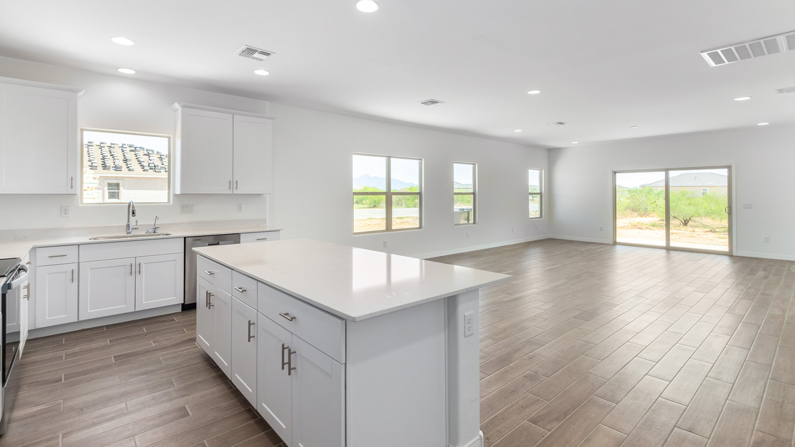 Welcome to The Sedona, a spacious and elegant single-story new home nestled in the expansive Sahuarita Acres community. Offering 2,530 square feet of living space, this home features five bedrooms and three bathrooms, designed to accommodate both comfort and functionality for modern family living.  As you step through the charming front porch, you are greeted by an inviting entryway that opens into a thoughtfully arranged interior. The heart of the home is the expansive great room, which seamlessly connects to the dining area and kitchen. This open-concept layout is perfect for those who enjoy entertaining or simply want a space where family life can flow naturally. The kitchen is a culinary haven, featuring a large island, sleek quartz countertops, and ample 42” upper cabinets for all your storage needs. A walk-in pantry ensures that your kitchen remains organized and efficient.  The primary bedroom is situated in its own private wing, offering a spacious walk-in closet and an en-suite bathroom with dual sinks and a luxurious shower. This room is designed as a peaceful haven, providing the perfect space to unwind at the end of the day. The additional four bedrooms are well-positioned within the home, each with easy access to one of the two additional bathrooms, making this layout ideal for families or hosting guests.  Outdoor living is a highlight of The Sedona, with a covered patio that extends from the great room, offering a seamless transition between indoor and outdoor spaces. Whether you envision hosting summer barbecues or simply enjoying the tranquility of your expansive one-acre lot, this outdoor space is perfect for creating your ideal backyard oasis.  Practical features of The Sedona include a three-car garage, which provides ample space for vehicles, storage, or even a workshop. The utility room is conveniently located near the kitchen, making household chores more manageable.  In line with modern living, The Sedona is equipped with D.R. Horton’s Home is Connected® Smart Home package, which includes a smart thermostat, video doorbell, keyless entry, a Wi-Fi-enabled garage door opener and more. The home is also designed with energy efficiency in mind, featuring spray foam insulation and meeting DOE Zero Energy Ready Home standards, ensuring long-term savings and environmental benefits.  Located within the peaceful Sahuarita Acres community, The Sedona offers residents the best of both worlds—spacious living with the conveniences of nearby urban amenities. Just 30 minutes from downtown Tucson and close to local attractions like the Titan Missile Museum and Madera Canyon, this home offers a lifestyle that embraces the essence of Arizona living.