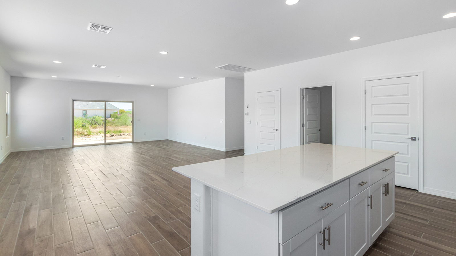 Welcome to The Sedona, a spacious and elegant single-story new home nestled in the expansive Sahuarita Acres community. Offering 2,530 square feet of living space, this home features five bedrooms and three bathrooms, designed to accommodate both comfort and functionality for modern family living.  As you step through the charming front porch, you are greeted by an inviting entryway that opens into a thoughtfully arranged interior. The heart of the home is the expansive great room, which seamlessly connects to the dining area and kitchen. This open-concept layout is perfect for those who enjoy entertaining or simply want a space where family life can flow naturally. The kitchen is a culinary haven, featuring a large island, sleek quartz countertops, and ample 42” upper cabinets for all your storage needs. A walk-in pantry ensures that your kitchen remains organized and efficient.  The primary bedroom is situated in its own private wing, offering a spacious walk-in closet and an en-suite bathroom with dual sinks and a luxurious shower. This room is designed as a peaceful haven, providing the perfect space to unwind at the end of the day. The additional four bedrooms are well-positioned within the home, each with easy access to one of the two additional bathrooms, making this layout ideal for families or hosting guests.  Outdoor living is a highlight of The Sedona, with a covered patio that extends from the great room, offering a seamless transition between indoor and outdoor spaces. Whether you envision hosting summer barbecues or simply enjoying the tranquility of your expansive one-acre lot, this outdoor space is perfect for creating your ideal backyard oasis.  Practical features of The Sedona include a three-car garage, which provides ample space for vehicles, storage, or even a workshop. The utility room is conveniently located near the kitchen, making household chores more manageable.  In line with modern living, The Sedona is equipped with D.R. Horton’s Home is Connected® Smart Home package, which includes a smart thermostat, video doorbell, keyless entry, a Wi-Fi-enabled garage door opener and more. The home is also designed with energy efficiency in mind, featuring spray foam insulation and meeting DOE Zero Energy Ready Home standards, ensuring long-term savings and environmental benefits.  Located within the peaceful Sahuarita Acres community, The Sedona offers residents the best of both worlds—spacious living with the conveniences of nearby urban amenities. Just 30 minutes from downtown Tucson and close to local attractions like the Titan Missile Museum and Madera Canyon, this home offers a lifestyle that embraces the essence of Arizona living.