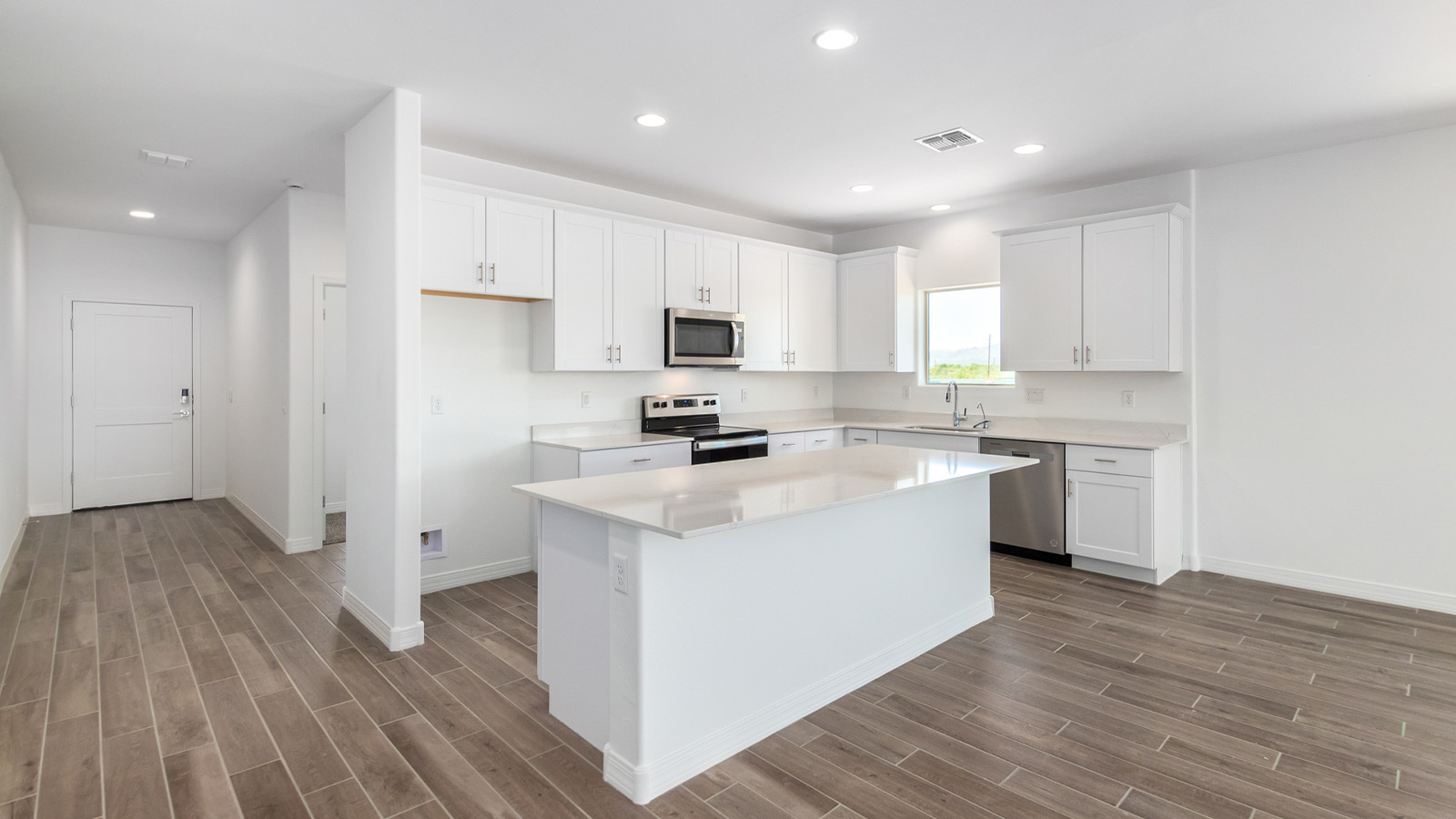 Welcome to The Sedona, a spacious and elegant single-story new home nestled in the expansive Sahuarita Acres community. Offering 2,530 square feet of living space, this home features five bedrooms and three bathrooms, designed to accommodate both comfort and functionality for modern family living.  As you step through the charming front porch, you are greeted by an inviting entryway that opens into a thoughtfully arranged interior. The heart of the home is the expansive great room, which seamlessly connects to the dining area and kitchen. This open-concept layout is perfect for those who enjoy entertaining or simply want a space where family life can flow naturally. The kitchen is a culinary haven, featuring a large island, sleek quartz countertops, and ample 42” upper cabinets for all your storage needs. A walk-in pantry ensures that your kitchen remains organized and efficient.  The primary bedroom is situated in its own private wing, offering a spacious walk-in closet and an en-suite bathroom with dual sinks and a luxurious shower. This room is designed as a peaceful haven, providing the perfect space to unwind at the end of the day. The additional four bedrooms are well-positioned within the home, each with easy access to one of the two additional bathrooms, making this layout ideal for families or hosting guests.  Outdoor living is a highlight of The Sedona, with a covered patio that extends from the great room, offering a seamless transition between indoor and outdoor spaces. Whether you envision hosting summer barbecues or simply enjoying the tranquility of your expansive one-acre lot, this outdoor space is perfect for creating your ideal backyard oasis.  Practical features of The Sedona include a three-car garage, which provides ample space for vehicles, storage, or even a workshop. The utility room is conveniently located near the kitchen, making household chores more manageable.  In line with modern living, The Sedona is equipped with D.R. Horton’s Home is Connected® Smart Home package, which includes a smart thermostat, video doorbell, keyless entry, a Wi-Fi-enabled garage door opener and more. The home is also designed with energy efficiency in mind, featuring spray foam insulation and meeting DOE Zero Energy Ready Home standards, ensuring long-term savings and environmental benefits.  Located within the peaceful Sahuarita Acres community, The Sedona offers residents the best of both worlds—spacious living with the conveniences of nearby urban amenities. Just 30 minutes from downtown Tucson and close to local attractions like the Titan Missile Museum and Madera Canyon, this home offers a lifestyle that embraces the essence of Arizona living.