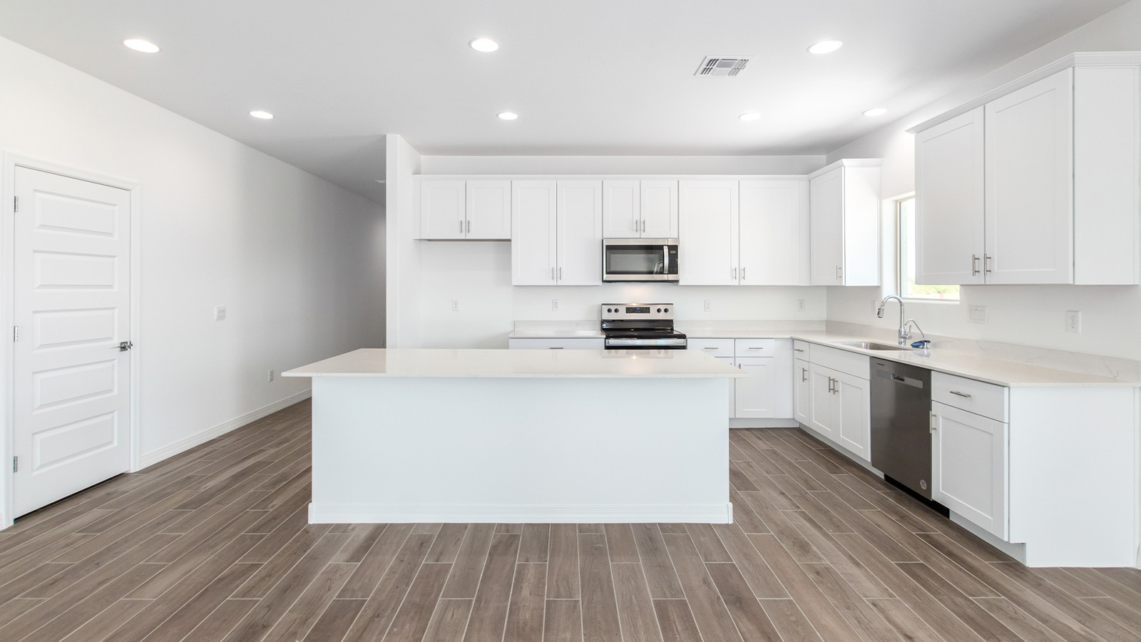 Welcome to The Sedona, a spacious and elegant single-story new home nestled in the expansive Sahuarita Acres community. Offering 2,530 square feet of living space, this home features five bedrooms and three bathrooms, designed to accommodate both comfort and functionality for modern family living.  As you step through the charming front porch, you are greeted by an inviting entryway that opens into a thoughtfully arranged interior. The heart of the home is the expansive great room, which seamlessly connects to the dining area and kitchen. This open-concept layout is perfect for those who enjoy entertaining or simply want a space where family life can flow naturally. The kitchen is a culinary haven, featuring a large island, sleek quartz countertops, and ample 42” upper cabinets for all your storage needs. A walk-in pantry ensures that your kitchen remains organized and efficient.  The primary bedroom is situated in its own private wing, offering a spacious walk-in closet and an en-suite bathroom with dual sinks and a luxurious shower. This room is designed as a peaceful haven, providing the perfect space to unwind at the end of the day. The additional four bedrooms are well-positioned within the home, each with easy access to one of the two additional bathrooms, making this layout ideal for families or hosting guests.  Outdoor living is a highlight of The Sedona, with a covered patio that extends from the great room, offering a seamless transition between indoor and outdoor spaces. Whether you envision hosting summer barbecues or simply enjoying the tranquility of your expansive one-acre lot, this outdoor space is perfect for creating your ideal backyard oasis.  Practical features of The Sedona include a three-car garage, which provides ample space for vehicles, storage, or even a workshop. The utility room is conveniently located near the kitchen, making household chores more manageable.  In line with modern living, The Sedona is equipped with D.R. Horton’s Home is Connected® Smart Home package, which includes a smart thermostat, video doorbell, keyless entry, a Wi-Fi-enabled garage door opener and more. The home is also designed with energy efficiency in mind, featuring spray foam insulation and meeting DOE Zero Energy Ready Home standards, ensuring long-term savings and environmental benefits.  Located within the peaceful Sahuarita Acres community, The Sedona offers residents the best of both worlds—spacious living with the conveniences of nearby urban amenities. Just 30 minutes from downtown Tucson and close to local attractions like the Titan Missile Museum and Madera Canyon, this home offers a lifestyle that embraces the essence of Arizona living.