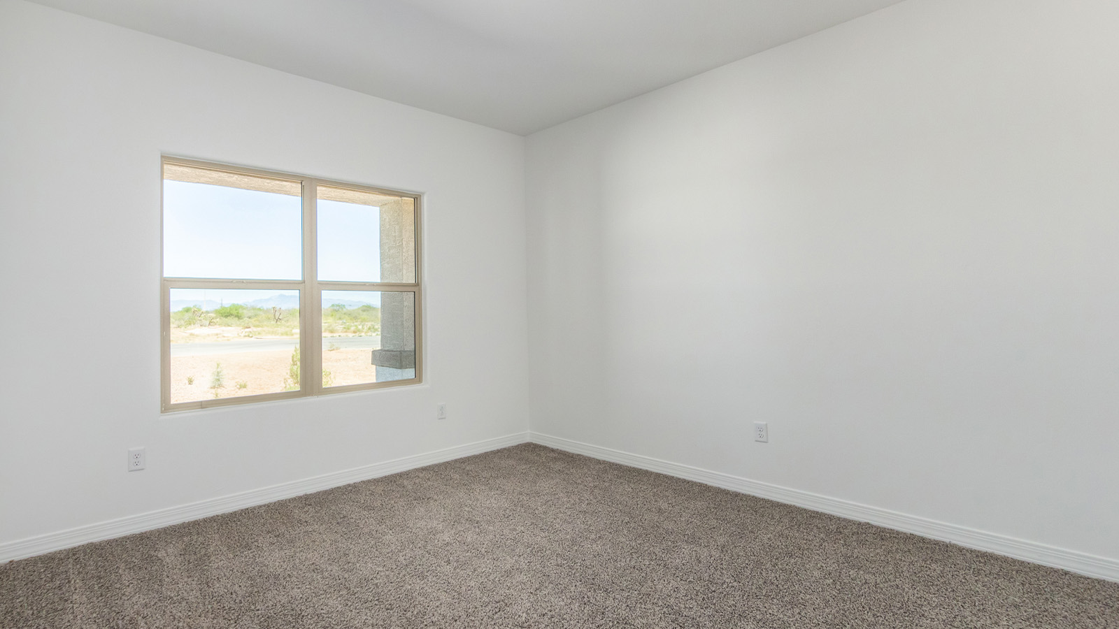 Welcome to The Sedona, a spacious and elegant single-story new home nestled in the expansive Sahuarita Acres community. Offering 2,530 square feet of living space, this home features five bedrooms and three bathrooms, designed to accommodate both comfort and functionality for modern family living.  As you step through the charming front porch, you are greeted by an inviting entryway that opens into a thoughtfully arranged interior. The heart of the home is the expansive great room, which seamlessly connects to the dining area and kitchen. This open-concept layout is perfect for those who enjoy entertaining or simply want a space where family life can flow naturally. The kitchen is a culinary haven, featuring a large island, sleek quartz countertops, and ample 42” upper cabinets for all your storage needs. A walk-in pantry ensures that your kitchen remains organized and efficient.  The primary bedroom is situated in its own private wing, offering a spacious walk-in closet and an en-suite bathroom with dual sinks and a luxurious shower. This room is designed as a peaceful haven, providing the perfect space to unwind at the end of the day. The additional four bedrooms are well-positioned within the home, each with easy access to one of the two additional bathrooms, making this layout ideal for families or hosting guests.  Outdoor living is a highlight of The Sedona, with a covered patio that extends from the great room, offering a seamless transition between indoor and outdoor spaces. Whether you envision hosting summer barbecues or simply enjoying the tranquility of your expansive one-acre lot, this outdoor space is perfect for creating your ideal backyard oasis.  Practical features of The Sedona include a three-car garage, which provides ample space for vehicles, storage, or even a workshop. The utility room is conveniently located near the kitchen, making household chores more manageable.  In line with modern living, The Sedona is equipped with D.R. Horton’s Home is Connected® Smart Home package, which includes a smart thermostat, video doorbell, keyless entry, a Wi-Fi-enabled garage door opener and more. The home is also designed with energy efficiency in mind, featuring spray foam insulation and meeting DOE Zero Energy Ready Home standards, ensuring long-term savings and environmental benefits.  Located within the peaceful Sahuarita Acres community, The Sedona offers residents the best of both worlds—spacious living with the conveniences of nearby urban amenities. Just 30 minutes from downtown Tucson and close to local attractions like the Titan Missile Museum and Madera Canyon, this home offers a lifestyle that embraces the essence of Arizona living.