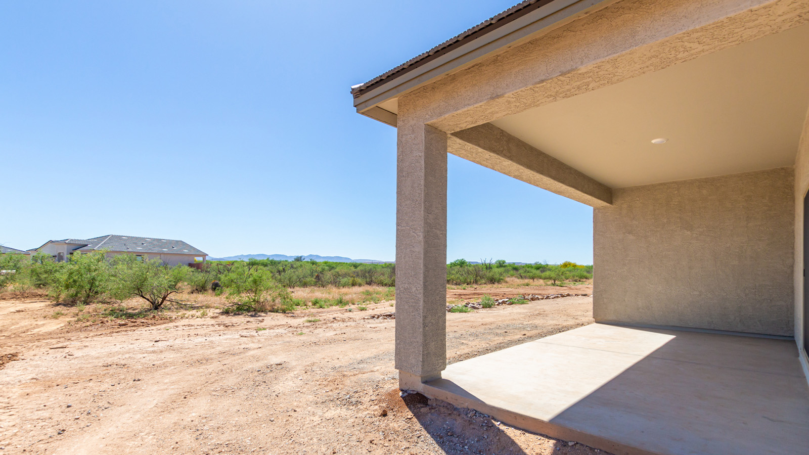 Welcome to The Sedona, a spacious and elegant single-story new home nestled in the expansive Sahuarita Acres community. Offering 2,530 square feet of living space, this home features five bedrooms and three bathrooms, designed to accommodate both comfort and functionality for modern family living.  As you step through the charming front porch, you are greeted by an inviting entryway that opens into a thoughtfully arranged interior. The heart of the home is the expansive great room, which seamlessly connects to the dining area and kitchen. This open-concept layout is perfect for those who enjoy entertaining or simply want a space where family life can flow naturally. The kitchen is a culinary haven, featuring a large island, sleek quartz countertops, and ample 42” upper cabinets for all your storage needs. A walk-in pantry ensures that your kitchen remains organized and efficient.  The primary bedroom is situated in its own private wing, offering a spacious walk-in closet and an en-suite bathroom with dual sinks and a luxurious shower. This room is designed as a peaceful haven, providing the perfect space to unwind at the end of the day. The additional four bedrooms are well-positioned within the home, each with easy access to one of the two additional bathrooms, making this layout ideal for families or hosting guests.  Outdoor living is a highlight of The Sedona, with a covered patio that extends from the great room, offering a seamless transition between indoor and outdoor spaces. Whether you envision hosting summer barbecues or simply enjoying the tranquility of your expansive one-acre lot, this outdoor space is perfect for creating your ideal backyard oasis.  Practical features of The Sedona include a three-car garage, which provides ample space for vehicles, storage, or even a workshop. The utility room is conveniently located near the kitchen, making household chores more manageable.  In line with modern living, The Sedona is equipped with D.R. Horton’s Home is Connected® Smart Home package, which includes a smart thermostat, video doorbell, keyless entry, a Wi-Fi-enabled garage door opener and more. The home is also designed with energy efficiency in mind, featuring spray foam insulation and meeting DOE Zero Energy Ready Home standards, ensuring long-term savings and environmental benefits.  Located within the peaceful Sahuarita Acres community, The Sedona offers residents the best of both worlds—spacious living with the conveniences of nearby urban amenities. Just 30 minutes from downtown Tucson and close to local attractions like the Titan Missile Museum and Madera Canyon, this home offers a lifestyle that embraces the essence of Arizona living.