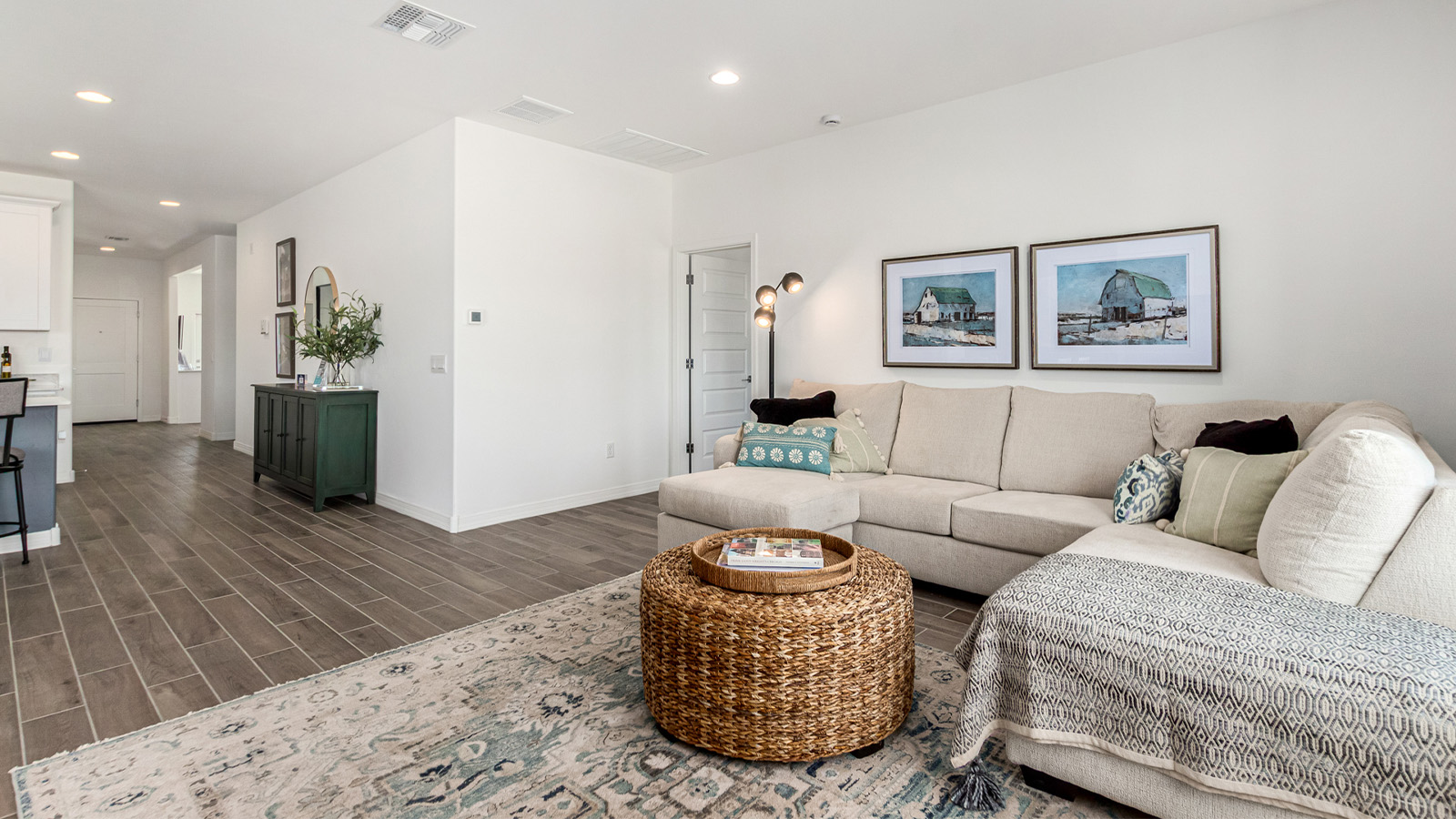 Introducing The Cali, a charming single-story new home located in the expansive Sahuarita Acres community. Covering 1,823 square feet, this home offers four bedrooms and two bathrooms, making it an excellent choice for families seeking both space and modern comfort.  As you step through the front porch and into the welcoming entryway, you’re immediately led into the heart of the home. The open-concept great room seamlessly connects to the dining area and kitchen, creating a perfect space for gathering with family and friends. The kitchen is a standout feature, boasting a central island, sleek granite countertops, and stylish 42” upper cabinets that offer ample storage. A spacious pantry adds to the kitchen’s functionality, ensuring everything you need is within reach.  The Cali’s layout is thoughtfully designed to maximize privacy and comfort. The primary bedroom, located at the rear of the home, features a large walk-in closet and an en-suite bathroom with dual sinks, providing a private space to start and end your day. The additional three bedrooms are situated toward the front of the home, each offering plenty of closet space and easy access to a full bathroom, making this layout ideal for families or guests.  One of the highlights of The Cali is the outdoor living space. The covered patio extends from the great room, offering an ideal spot to enjoy the expansive near one-acre lots that Sahuarita Acres is known for. Whether you’re planning to create a dream outdoor oasis or simply enjoy the natural surroundings, this space offers endless possibilities.  Built with modern living in mind, The Cali includes D.R. Horton’s Home is Connected® Smart Home package, featuring a smart thermostat, video doorbell, keyless entry, and a Wi-Fi-enabled garage door opener. Energy efficiency is also a priority, with spray foam insulation and designs that meet the DOE Zero Energy Ready Home standards, ensuring long-term savings and environmental benefits.  Located within the serene Sahuarita Acres community, residents of The Cali enjoy the luxury of space combined with easy access to urban amenities. With a three-car garage and RV parking on a 30’ driveway, this home is designed to accommodate your lifestyle while offering a peaceful retreat from the hustle and bustle.  Come home to The Cali, where comfort, style, and the beauty of Arizona living come together in perfect harmony.