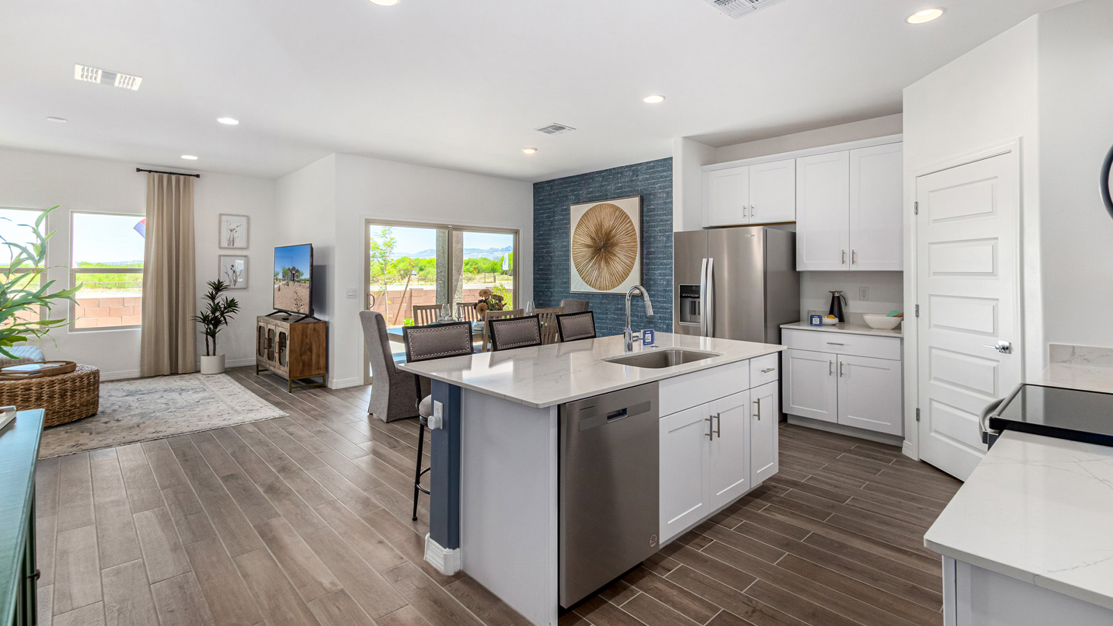 Introducing The Cali, a charming single-story new home located in the expansive Sahuarita Acres community. Covering 1,823 square feet, this home offers four bedrooms and two bathrooms, making it an excellent choice for families seeking both space and modern comfort.  As you step through the front porch and into the welcoming entryway, you’re immediately led into the heart of the home. The open-concept great room seamlessly connects to the dining area and kitchen, creating a perfect space for gathering with family and friends. The kitchen is a standout feature, boasting a central island, sleek granite countertops, and stylish 42” upper cabinets that offer ample storage. A spacious pantry adds to the kitchen’s functionality, ensuring everything you need is within reach.  The Cali’s layout is thoughtfully designed to maximize privacy and comfort. The primary bedroom, located at the rear of the home, features a large walk-in closet and an en-suite bathroom with dual sinks, providing a private space to start and end your day. The additional three bedrooms are situated toward the front of the home, each offering plenty of closet space and easy access to a full bathroom, making this layout ideal for families or guests.  One of the highlights of The Cali is the outdoor living space. The covered patio extends from the great room, offering an ideal spot to enjoy the expansive near one-acre lots that Sahuarita Acres is known for. Whether you’re planning to create a dream outdoor oasis or simply enjoy the natural surroundings, this space offers endless possibilities.  Built with modern living in mind, The Cali includes D.R. Horton’s Home is Connected® Smart Home package, featuring a smart thermostat, video doorbell, keyless entry, and a Wi-Fi-enabled garage door opener. Energy efficiency is also a priority, with spray foam insulation and designs that meet the DOE Zero Energy Ready Home standards, ensuring long-term savings and environmental benefits.  Located within the serene Sahuarita Acres community, residents of The Cali enjoy the luxury of space combined with easy access to urban amenities. With a three-car garage and RV parking on a 30’ driveway, this home is designed to accommodate your lifestyle while offering a peaceful retreat from the hustle and bustle.  Come home to The Cali, where comfort, style, and the beauty of Arizona living come together in perfect harmony.