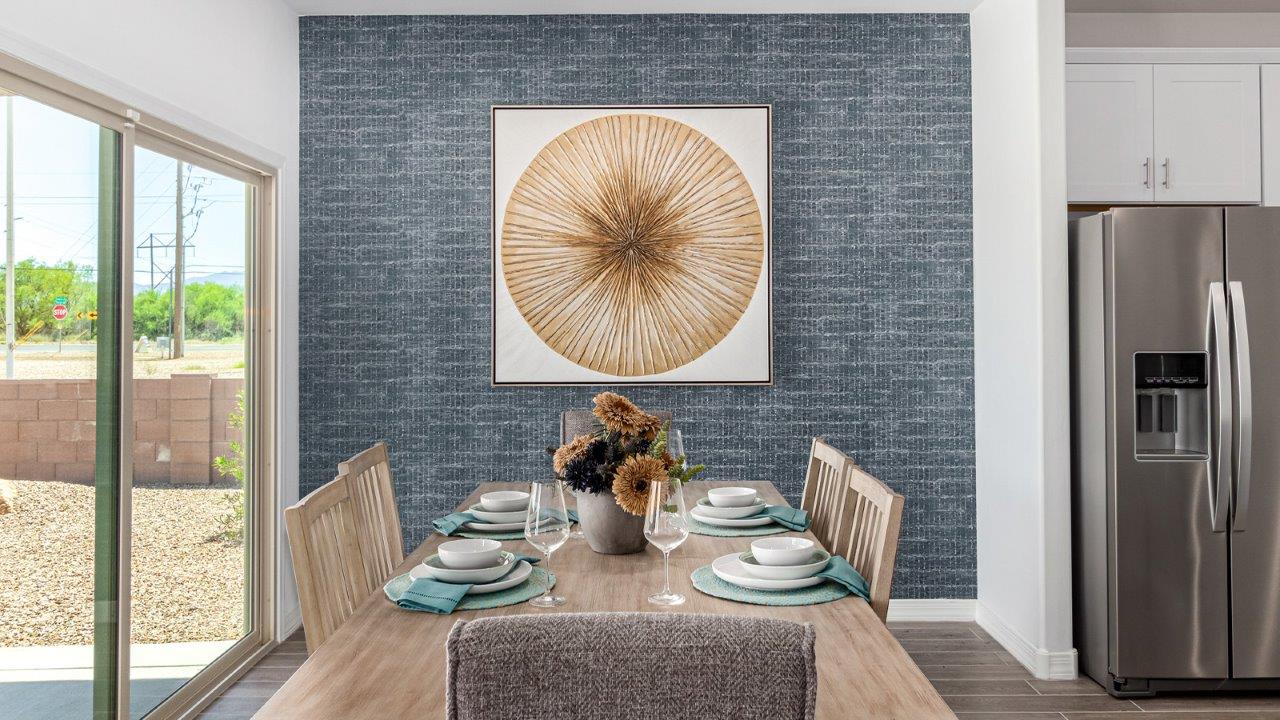 Introducing The Cali, a charming single-story new home located in the expansive Sahuarita Acres community. Covering 1,823 square feet, this home offers four bedrooms and two bathrooms, making it an excellent choice for families seeking both space and modern comfort.  As you step through the front porch and into the welcoming entryway, you’re immediately led into the heart of the home. The open-concept great room seamlessly connects to the dining area and kitchen, creating a perfect space for gathering with family and friends. The kitchen is a standout feature, boasting a central island, sleek granite countertops, and stylish 42” upper cabinets that offer ample storage. A spacious pantry adds to the kitchen’s functionality, ensuring everything you need is within reach.  The Cali’s layout is thoughtfully designed to maximize privacy and comfort. The primary bedroom, located at the rear of the home, features a large walk-in closet and an en-suite bathroom with dual sinks, providing a private space to start and end your day. The additional three bedrooms are situated toward the front of the home, each offering plenty of closet space and easy access to a full bathroom, making this layout ideal for families or guests.  One of the highlights of The Cali is the outdoor living space. The covered patio extends from the great room, offering an ideal spot to enjoy the expansive near one-acre lots that Sahuarita Acres is known for. Whether you’re planning to create a dream outdoor oasis or simply enjoy the natural surroundings, this space offers endless possibilities.  Built with modern living in mind, The Cali includes D.R. Horton’s Home is Connected® Smart Home package, featuring a smart thermostat, video doorbell, keyless entry, and a Wi-Fi-enabled garage door opener. Energy efficiency is also a priority, with spray foam insulation and designs that meet the DOE Zero Energy Ready Home standards, ensuring long-term savings and environmental benefits.  Located within the serene Sahuarita Acres community, residents of The Cali enjoy the luxury of space combined with easy access to urban amenities. With a three-car garage and RV parking on a 30’ driveway, this home is designed to accommodate your lifestyle while offering a peaceful retreat from the hustle and bustle.  Come home to The Cali, where comfort, style, and the beauty of Arizona living come together in perfect harmony.