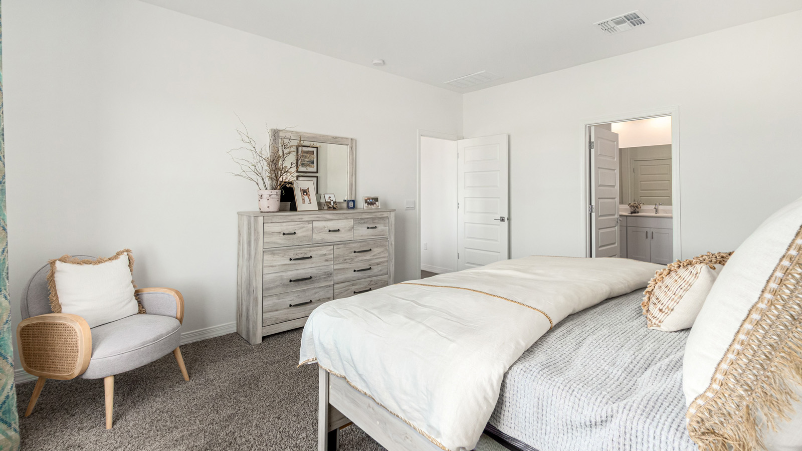 Introducing The Cali, a charming single-story new home located in the expansive Sahuarita Acres community. Covering 1,823 square feet, this home offers four bedrooms and two bathrooms, making it an excellent choice for families seeking both space and modern comfort.  As you step through the front porch and into the welcoming entryway, you’re immediately led into the heart of the home. The open-concept great room seamlessly connects to the dining area and kitchen, creating a perfect space for gathering with family and friends. The kitchen is a standout feature, boasting a central island, sleek granite countertops, and stylish 42” upper cabinets that offer ample storage. A spacious pantry adds to the kitchen’s functionality, ensuring everything you need is within reach.  The Cali’s layout is thoughtfully designed to maximize privacy and comfort. The primary bedroom, located at the rear of the home, features a large walk-in closet and an en-suite bathroom with dual sinks, providing a private space to start and end your day. The additional three bedrooms are situated toward the front of the home, each offering plenty of closet space and easy access to a full bathroom, making this layout ideal for families or guests.  One of the highlights of The Cali is the outdoor living space. The covered patio extends from the great room, offering an ideal spot to enjoy the expansive near one-acre lots that Sahuarita Acres is known for. Whether you’re planning to create a dream outdoor oasis or simply enjoy the natural surroundings, this space offers endless possibilities.  Built with modern living in mind, The Cali includes D.R. Horton’s Home is Connected® Smart Home package, featuring a smart thermostat, video doorbell, keyless entry, and a Wi-Fi-enabled garage door opener. Energy efficiency is also a priority, with spray foam insulation and designs that meet the DOE Zero Energy Ready Home standards, ensuring long-term savings and environmental benefits.  Located within the serene Sahuarita Acres community, residents of The Cali enjoy the luxury of space combined with easy access to urban amenities. With a three-car garage and RV parking on a 30’ driveway, this home is designed to accommodate your lifestyle while offering a peaceful retreat from the hustle and bustle.  Come home to The Cali, where comfort, style, and the beauty of Arizona living come together in perfect harmony.