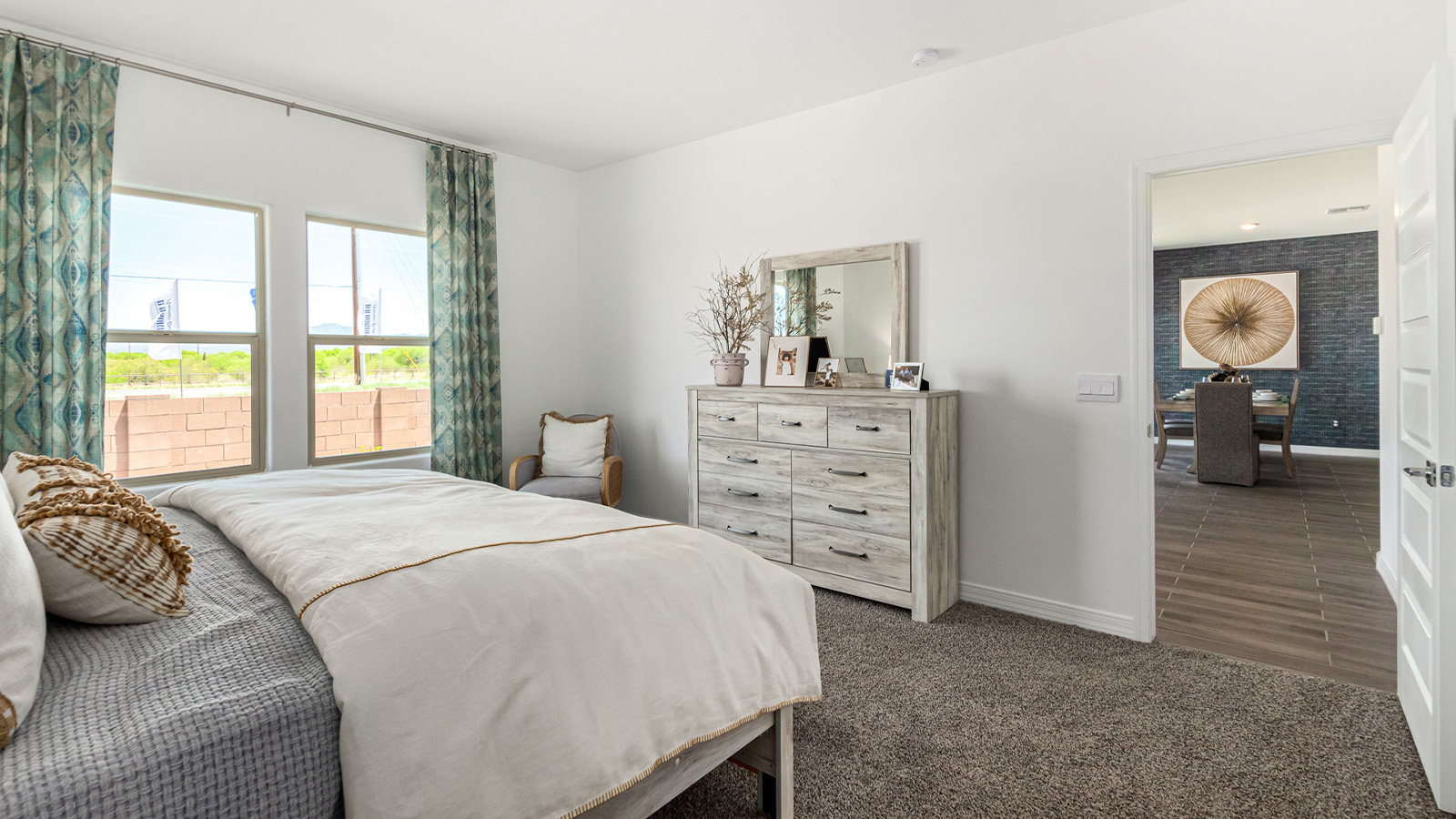 Introducing The Cali, a charming single-story new home located in the expansive Sahuarita Acres community. Covering 1,823 square feet, this home offers four bedrooms and two bathrooms, making it an excellent choice for families seeking both space and modern comfort.  As you step through the front porch and into the welcoming entryway, you’re immediately led into the heart of the home. The open-concept great room seamlessly connects to the dining area and kitchen, creating a perfect space for gathering with family and friends. The kitchen is a standout feature, boasting a central island, sleek granite countertops, and stylish 42” upper cabinets that offer ample storage. A spacious pantry adds to the kitchen’s functionality, ensuring everything you need is within reach.  The Cali’s layout is thoughtfully designed to maximize privacy and comfort. The primary bedroom, located at the rear of the home, features a large walk-in closet and an en-suite bathroom with dual sinks, providing a private space to start and end your day. The additional three bedrooms are situated toward the front of the home, each offering plenty of closet space and easy access to a full bathroom, making this layout ideal for families or guests.  One of the highlights of The Cali is the outdoor living space. The covered patio extends from the great room, offering an ideal spot to enjoy the expansive near one-acre lots that Sahuarita Acres is known for. Whether you’re planning to create a dream outdoor oasis or simply enjoy the natural surroundings, this space offers endless possibilities.  Built with modern living in mind, The Cali includes D.R. Horton’s Home is Connected® Smart Home package, featuring a smart thermostat, video doorbell, keyless entry, and a Wi-Fi-enabled garage door opener. Energy efficiency is also a priority, with spray foam insulation and designs that meet the DOE Zero Energy Ready Home standards, ensuring long-term savings and environmental benefits.  Located within the serene Sahuarita Acres community, residents of The Cali enjoy the luxury of space combined with easy access to urban amenities. With a three-car garage and RV parking on a 30’ driveway, this home is designed to accommodate your lifestyle while offering a peaceful retreat from the hustle and bustle.  Come home to The Cali, where comfort, style, and the beauty of Arizona living come together in perfect harmony.