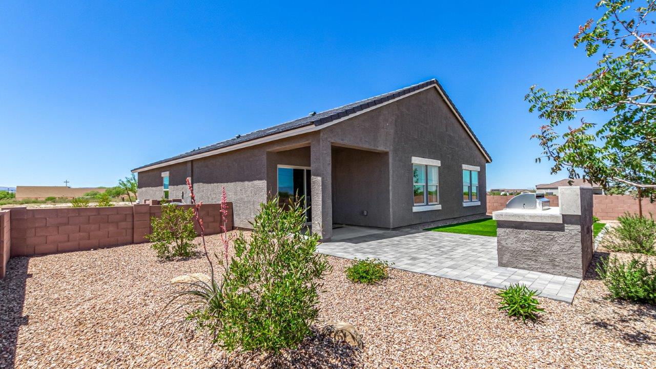 Introducing The Cali, a charming single-story new home located in the expansive Sahuarita Acres community. Covering 1,823 square feet, this home offers four bedrooms and two bathrooms, making it an excellent choice for families seeking both space and modern comfort.  As you step through the front porch and into the welcoming entryway, you’re immediately led into the heart of the home. The open-concept great room seamlessly connects to the dining area and kitchen, creating a perfect space for gathering with family and friends. The kitchen is a standout feature, boasting a central island, sleek granite countertops, and stylish 42” upper cabinets that offer ample storage. A spacious pantry adds to the kitchen’s functionality, ensuring everything you need is within reach.  The Cali’s layout is thoughtfully designed to maximize privacy and comfort. The primary bedroom, located at the rear of the home, features a large walk-in closet and an en-suite bathroom with dual sinks, providing a private space to start and end your day. The additional three bedrooms are situated toward the front of the home, each offering plenty of closet space and easy access to a full bathroom, making this layout ideal for families or guests.  One of the highlights of The Cali is the outdoor living space. The covered patio extends from the great room, offering an ideal spot to enjoy the expansive near one-acre lots that Sahuarita Acres is known for. Whether you’re planning to create a dream outdoor oasis or simply enjoy the natural surroundings, this space offers endless possibilities.  Built with modern living in mind, The Cali includes D.R. Horton’s Home is Connected® Smart Home package, featuring a smart thermostat, video doorbell, keyless entry, and a Wi-Fi-enabled garage door opener. Energy efficiency is also a priority, with spray foam insulation and designs that meet the DOE Zero Energy Ready Home standards, ensuring long-term savings and environmental benefits.  Located within the serene Sahuarita Acres community, residents of The Cali enjoy the luxury of space combined with easy access to urban amenities. With a three-car garage and RV parking on a 30’ driveway, this home is designed to accommodate your lifestyle while offering a peaceful retreat from the hustle and bustle.  Come home to The Cali, where comfort, style, and the beauty of Arizona living come together in perfect harmony.