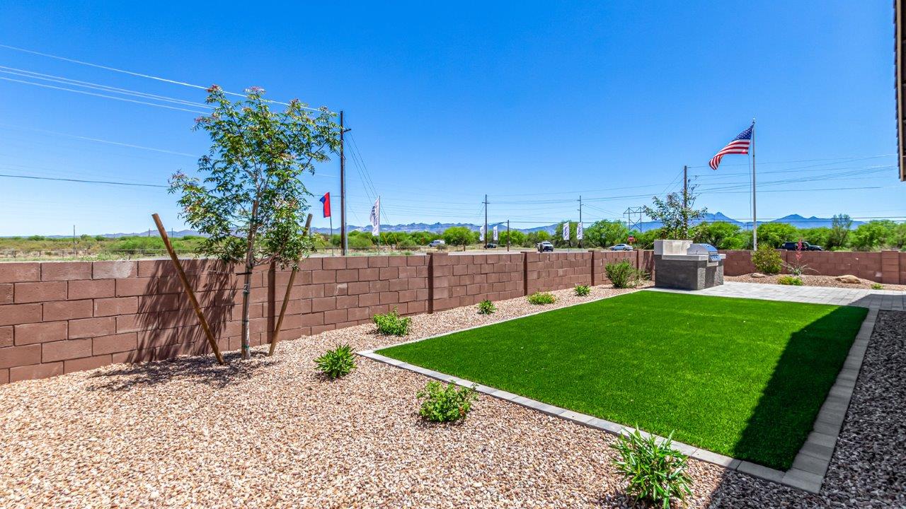 Introducing The Cali, a charming single-story new home located in the expansive Sahuarita Acres community. Covering 1,823 square feet, this home offers four bedrooms and two bathrooms, making it an excellent choice for families seeking both space and modern comfort.  As you step through the front porch and into the welcoming entryway, you’re immediately led into the heart of the home. The open-concept great room seamlessly connects to the dining area and kitchen, creating a perfect space for gathering with family and friends. The kitchen is a standout feature, boasting a central island, sleek granite countertops, and stylish 42” upper cabinets that offer ample storage. A spacious pantry adds to the kitchen’s functionality, ensuring everything you need is within reach.  The Cali’s layout is thoughtfully designed to maximize privacy and comfort. The primary bedroom, located at the rear of the home, features a large walk-in closet and an en-suite bathroom with dual sinks, providing a private space to start and end your day. The additional three bedrooms are situated toward the front of the home, each offering plenty of closet space and easy access to a full bathroom, making this layout ideal for families or guests.  One of the highlights of The Cali is the outdoor living space. The covered patio extends from the great room, offering an ideal spot to enjoy the expansive near one-acre lots that Sahuarita Acres is known for. Whether you’re planning to create a dream outdoor oasis or simply enjoy the natural surroundings, this space offers endless possibilities.  Built with modern living in mind, The Cali includes D.R. Horton’s Home is Connected® Smart Home package, featuring a smart thermostat, video doorbell, keyless entry, and a Wi-Fi-enabled garage door opener. Energy efficiency is also a priority, with spray foam insulation and designs that meet the DOE Zero Energy Ready Home standards, ensuring long-term savings and environmental benefits.  Located within the serene Sahuarita Acres community, residents of The Cali enjoy the luxury of space combined with easy access to urban amenities. With a three-car garage and RV parking on a 30’ driveway, this home is designed to accommodate your lifestyle while offering a peaceful retreat from the hustle and bustle.  Come home to The Cali, where comfort, style, and the beauty of Arizona living come together in perfect harmony.